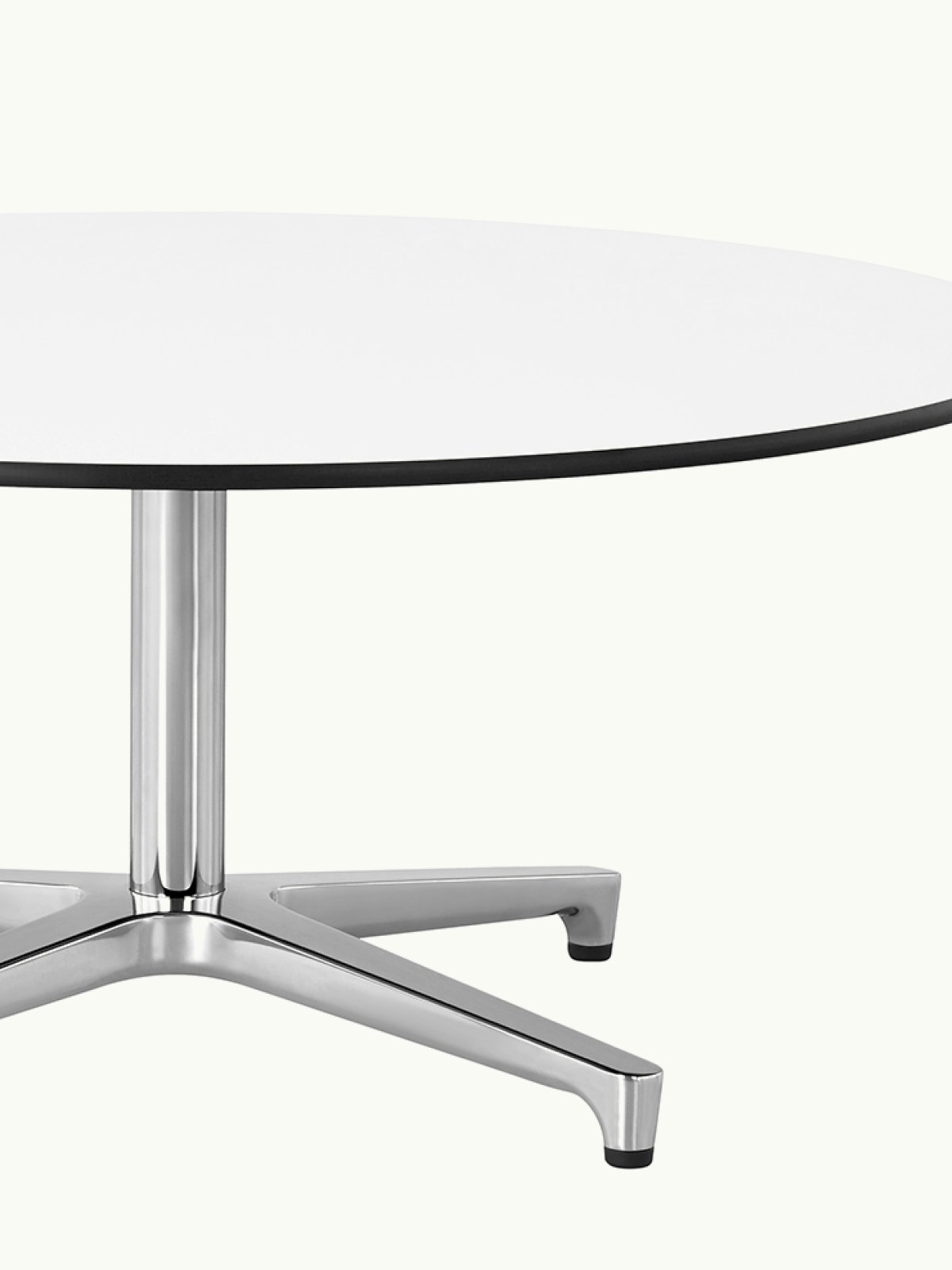 Close-up view of a round Saiba Coffee Table; showing the white back-painted glass top.