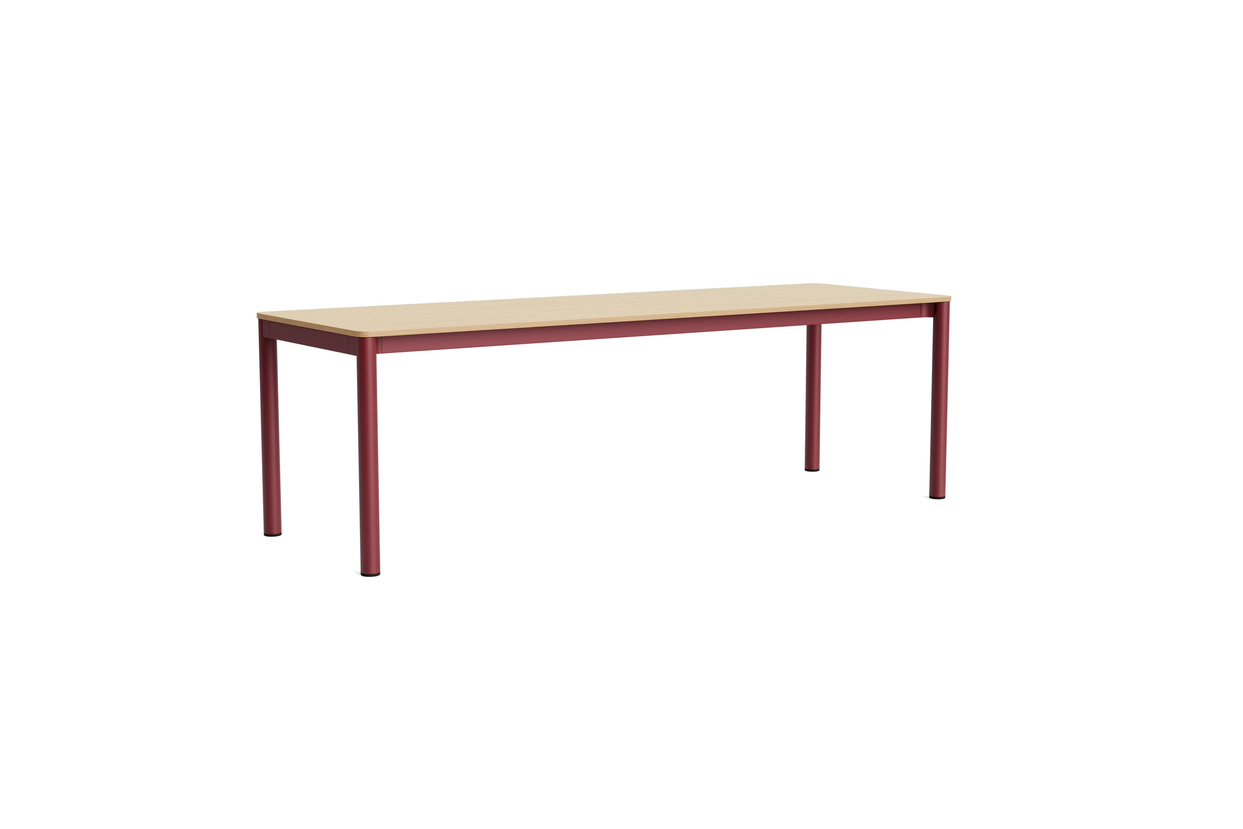 Annex flush table with red legs and light wood top, angled from front left.