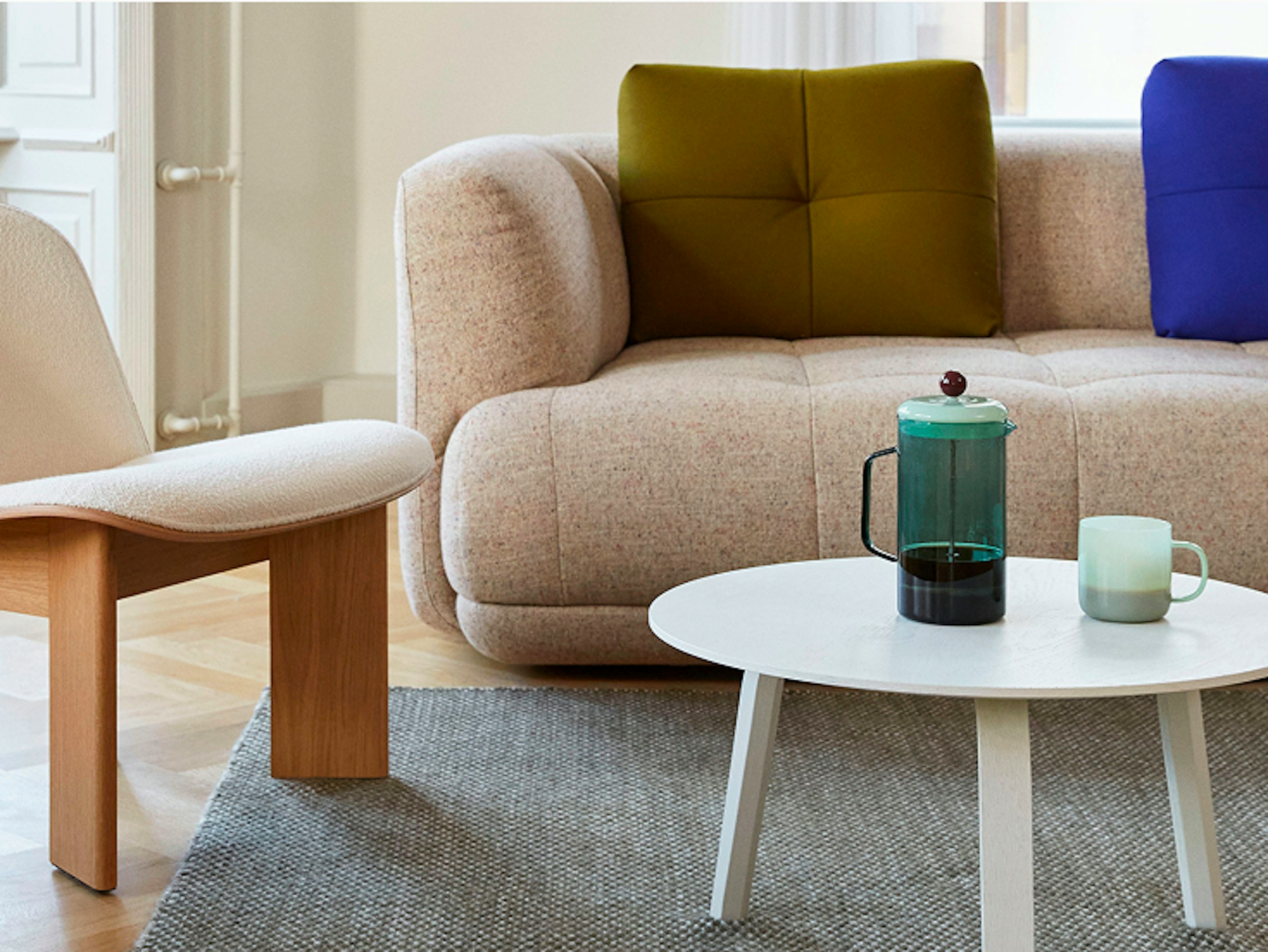 A HAY Flamiber Cream Chisel Lounge Chair and a Lacquered Oak Quilton 3 Seater Sofa in a residential setting