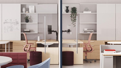 Modern workstations with white desks, pink chairs, and storage units. Glass partitions divide the space. Shelving displays plants and decorative items. Meeting area with roundtable and red sofa in the foreground.