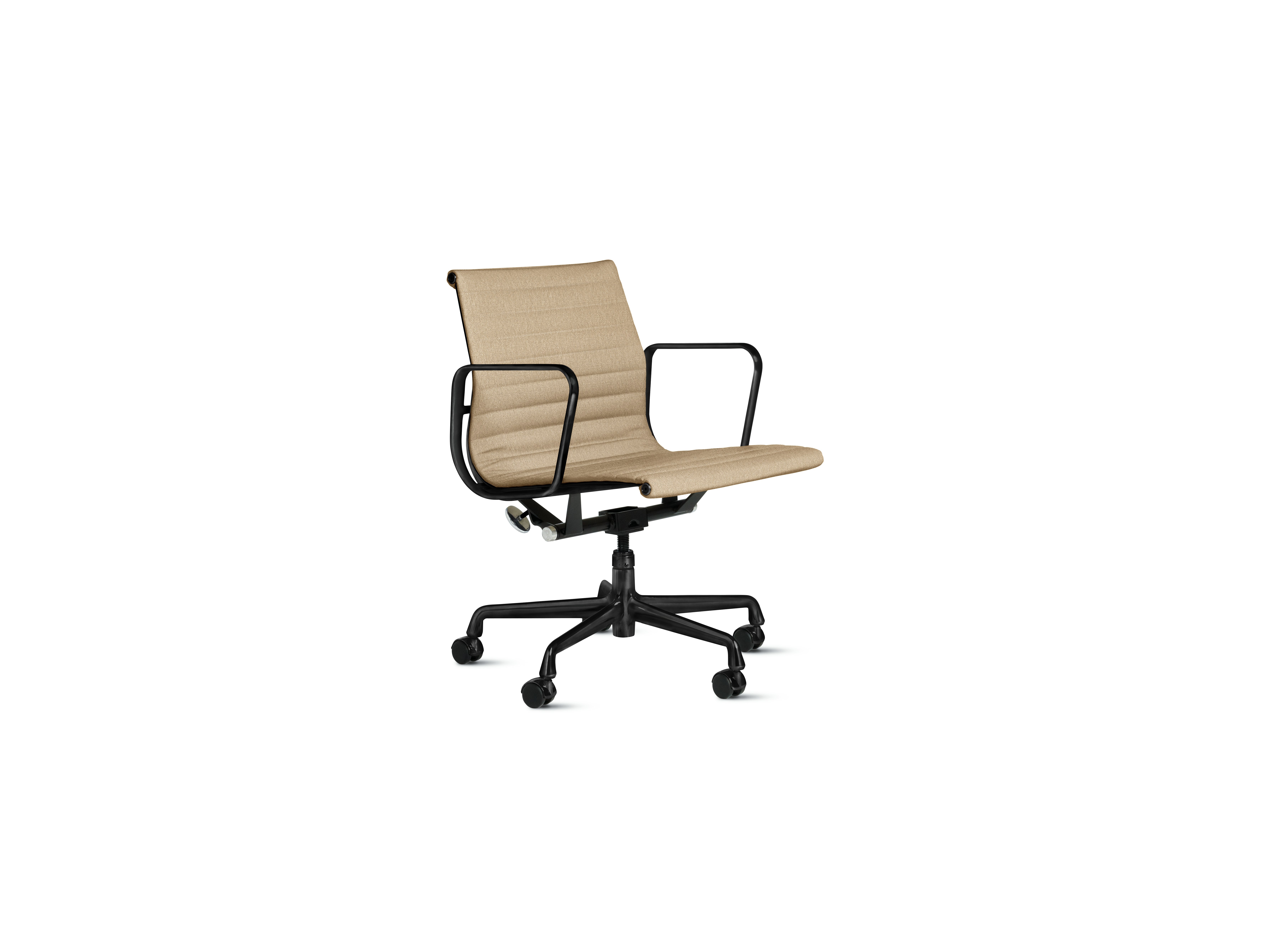A Eames Aluminum Group Chairs in straw and black viewed from an angle.