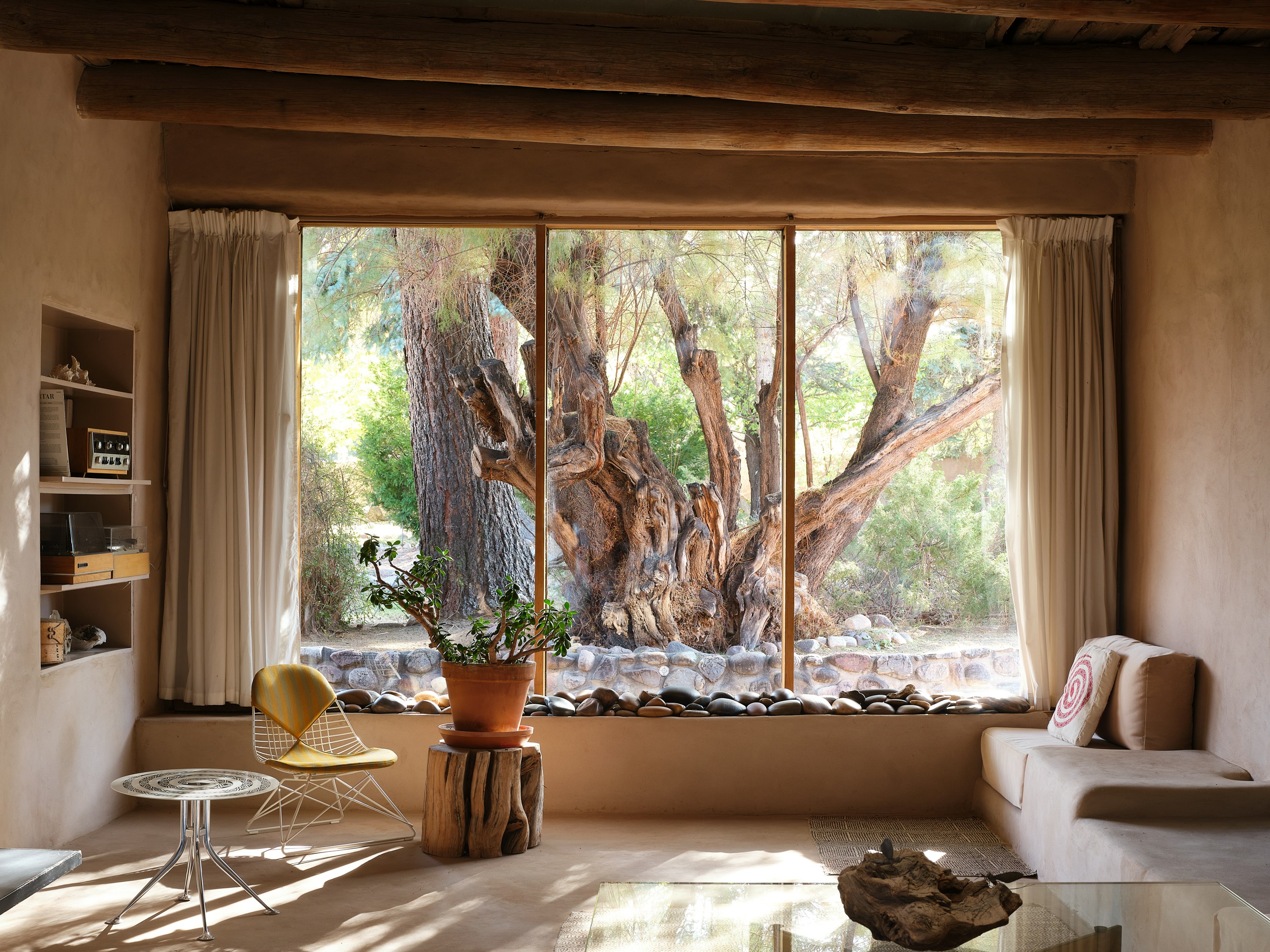 A Girard Snake Table and Eames Wire Chair Low Wire Base pictured inside the Georgia O'Keeffe house in New Mexico.