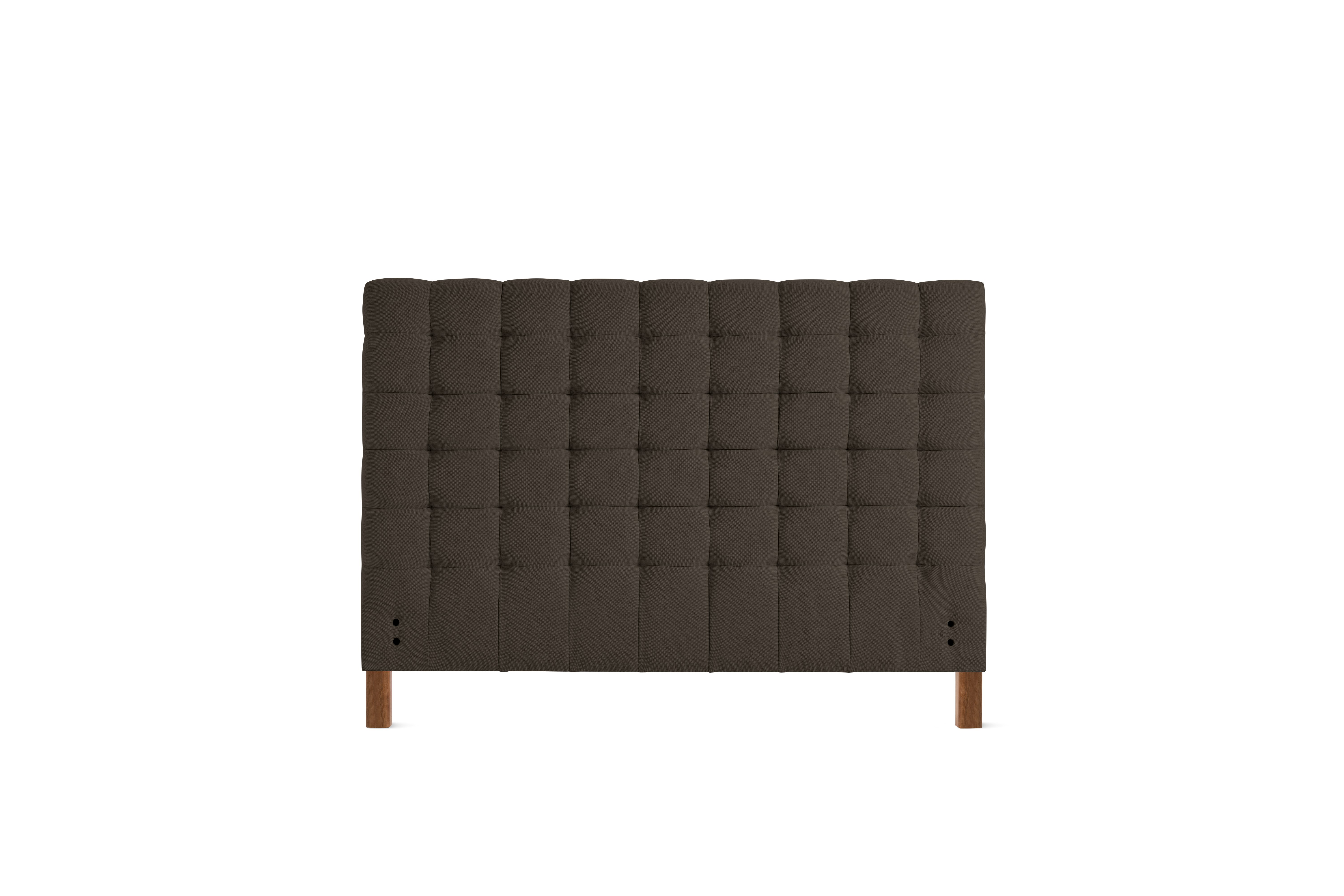 A Madeleine Headboard in Mode, Hollow, Walnut viewed from the front.