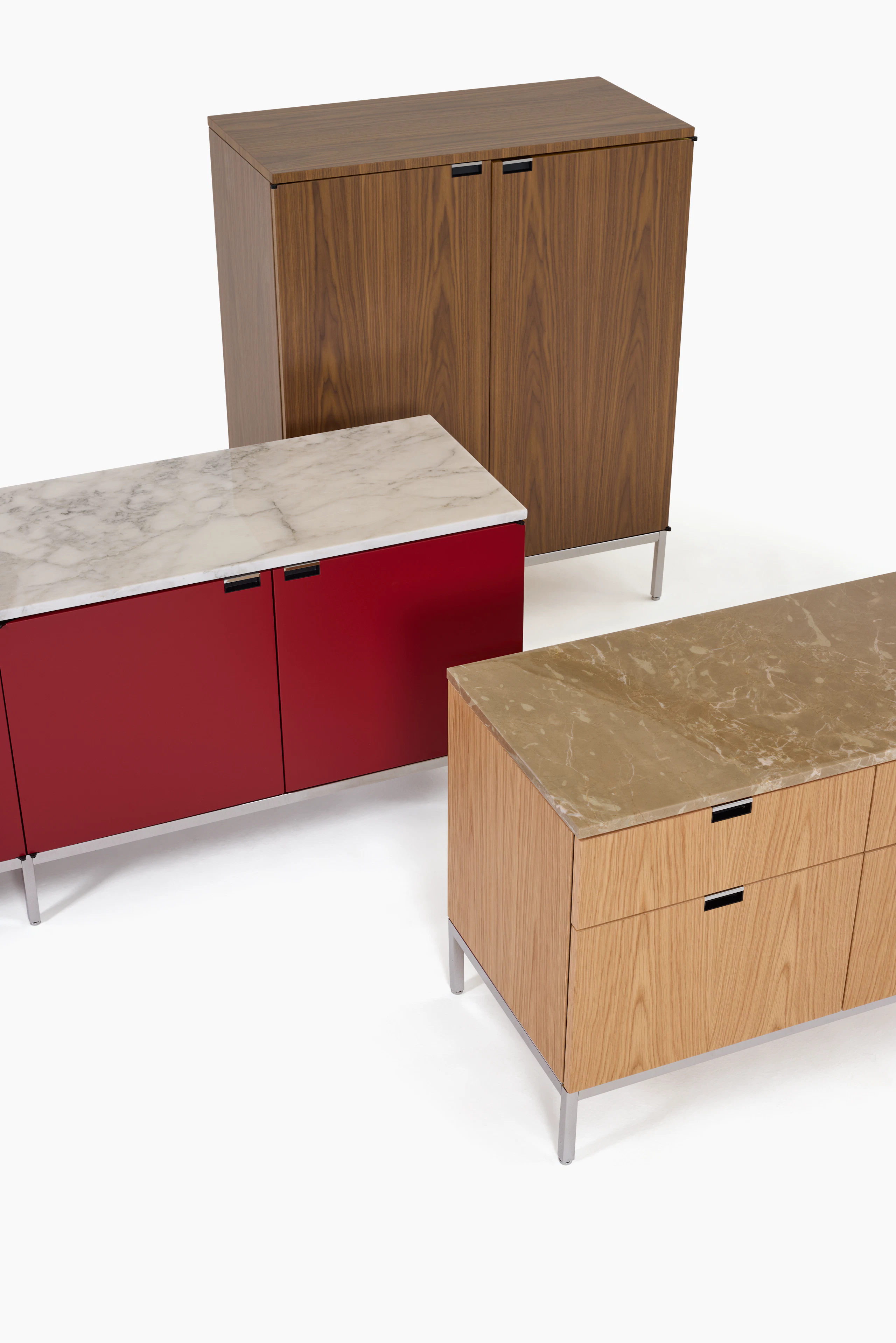 Three Florence Knoll Credenzas in various sizes, colors, and materials.