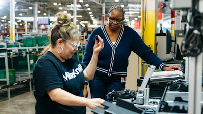Two people working together in a warehouse facility.