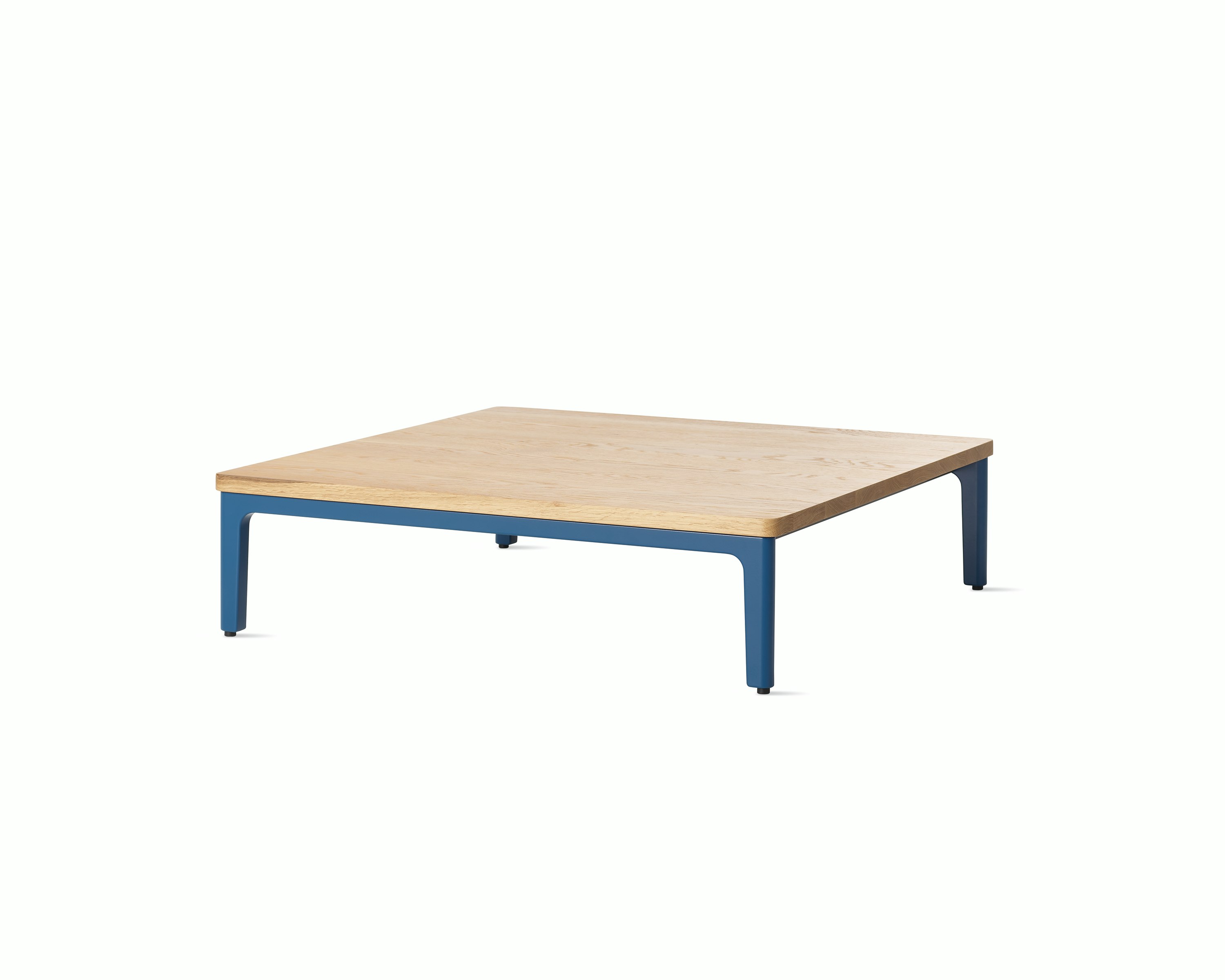 Angle view Mimo Coffee Table with blue legs and solid oak top on white background.