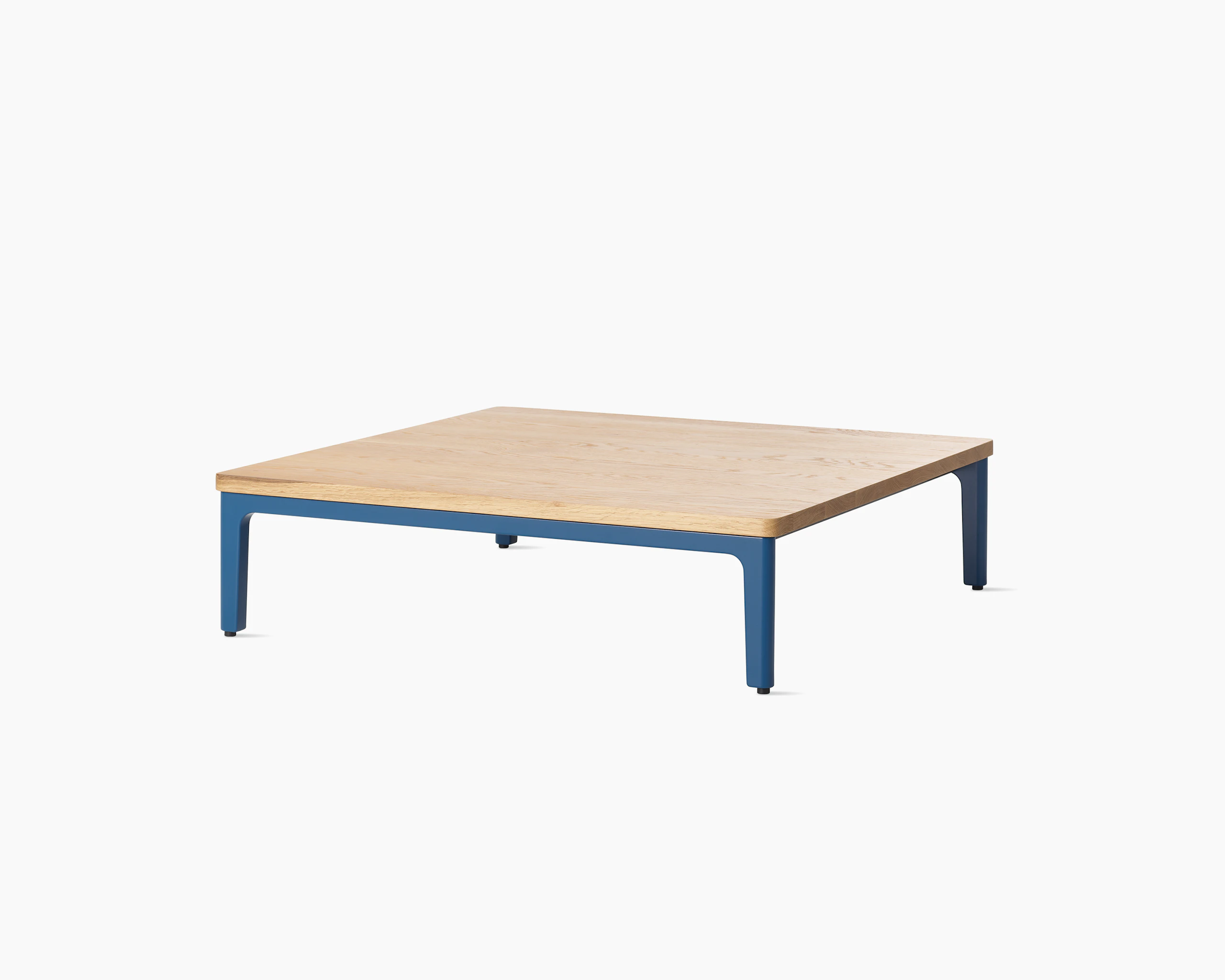 Angle view Mimo Coffee Table with blue legs and solid oak top on white background.