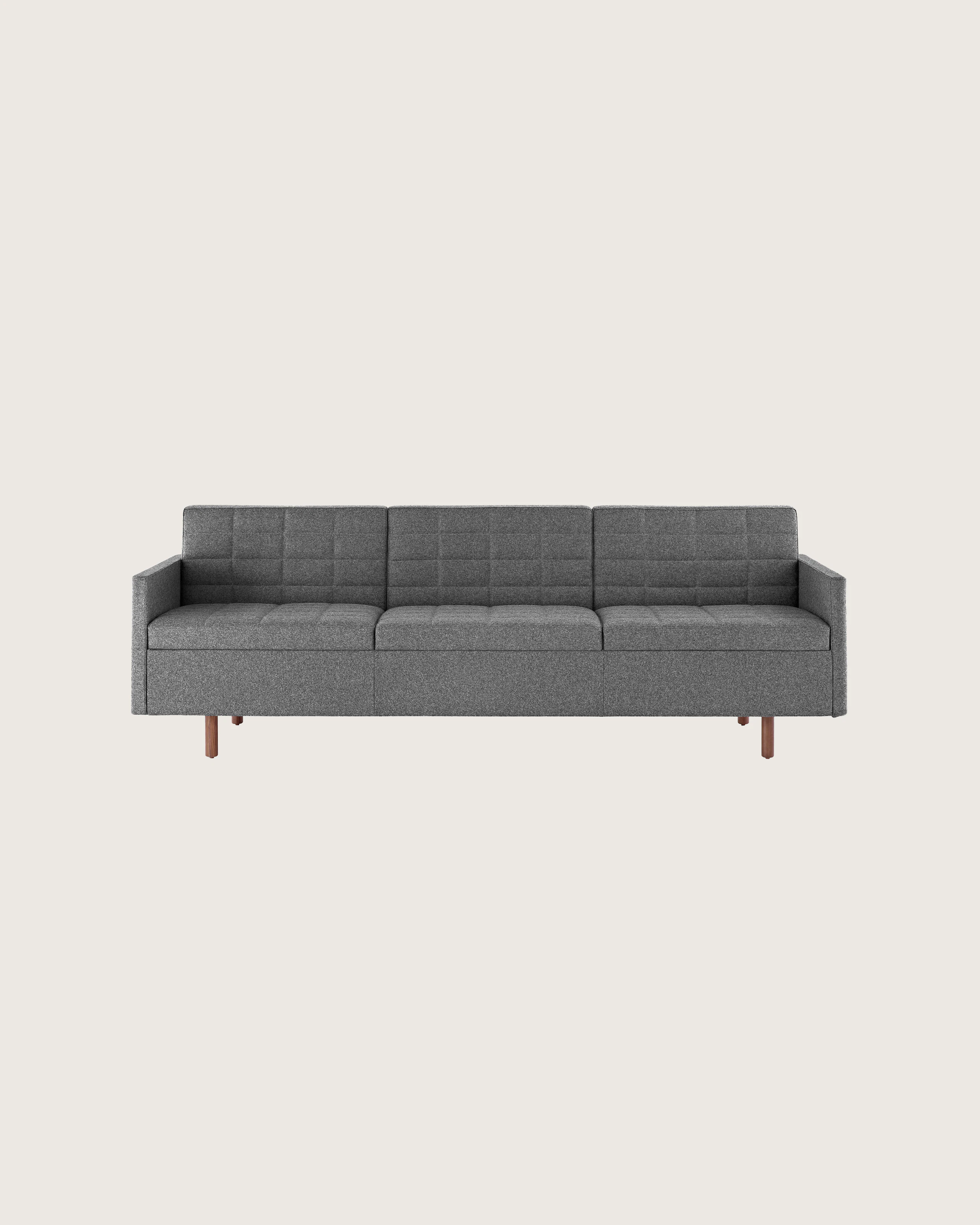 A Tuxedo Classic sofa with dark gray quilted upholstery, viewed from the front.