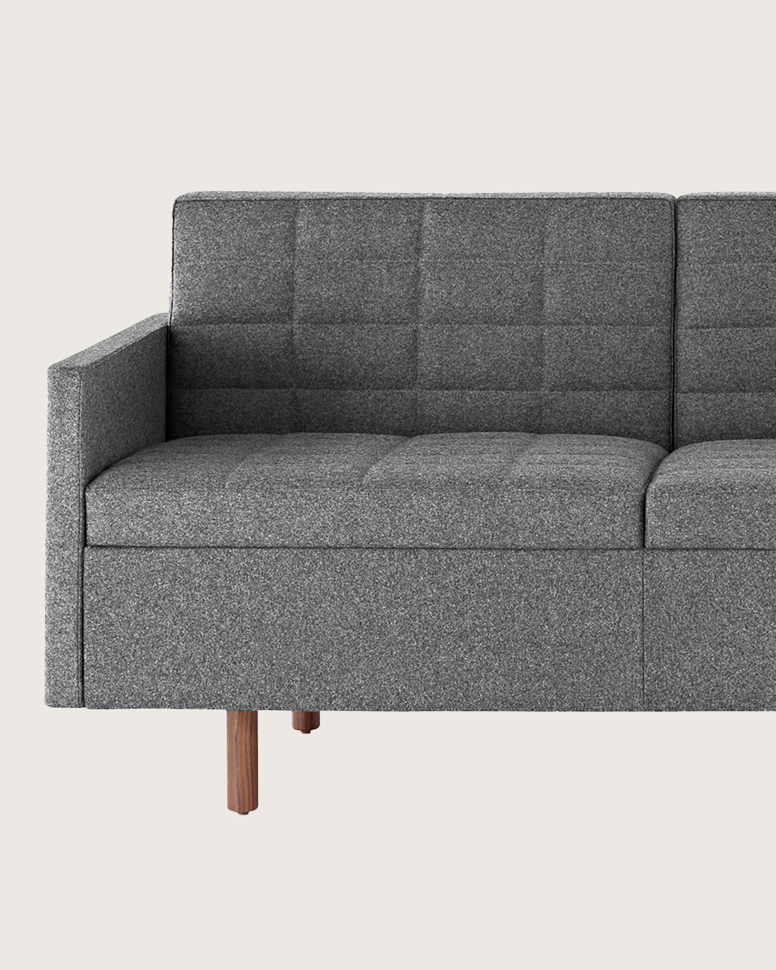 A Tuxedo Classic sofa with dark gray quilted upholstery, viewed from the front.