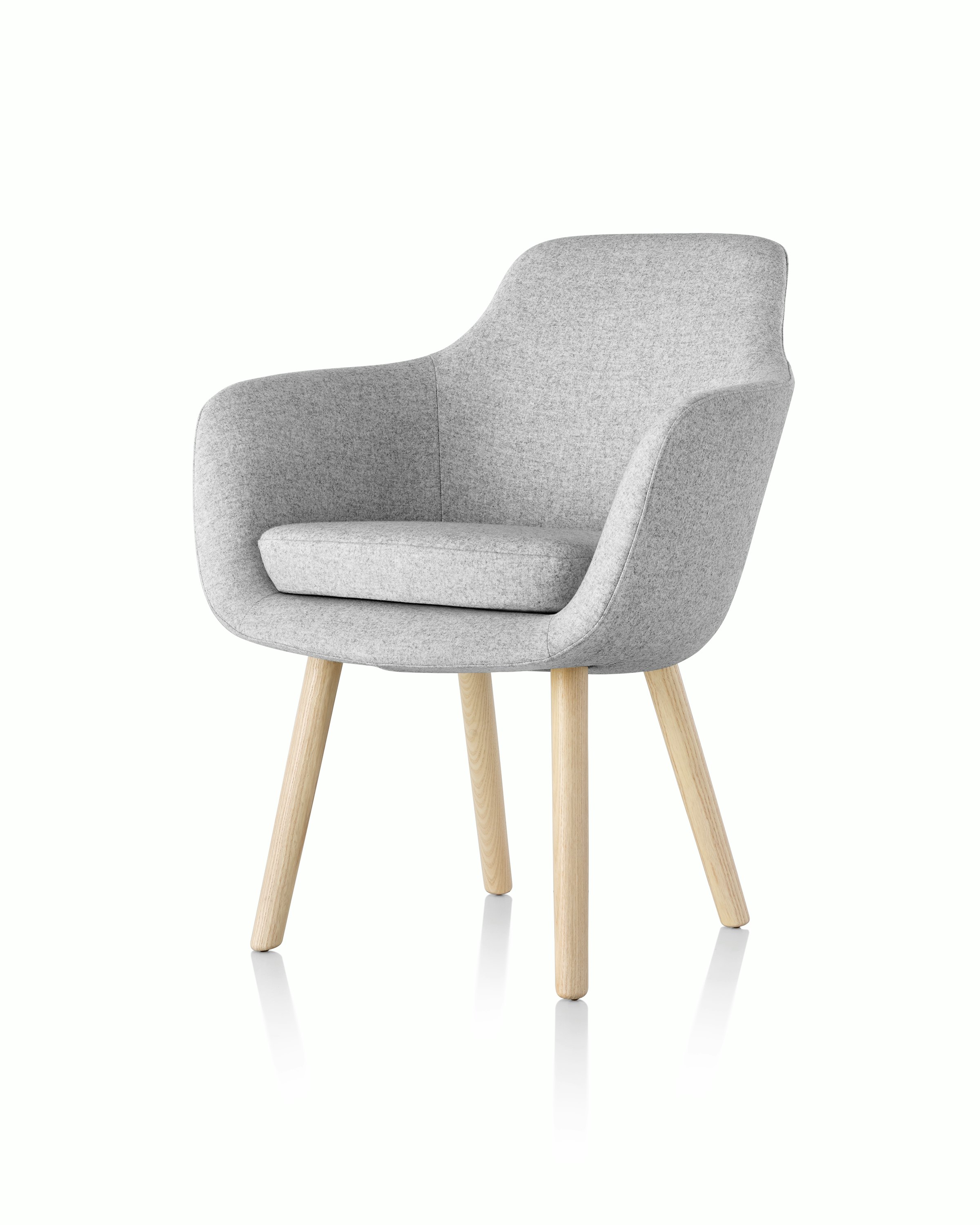 Angled view of a Saiba Side Chair with light gray upholstery and wood legs in a light finish.