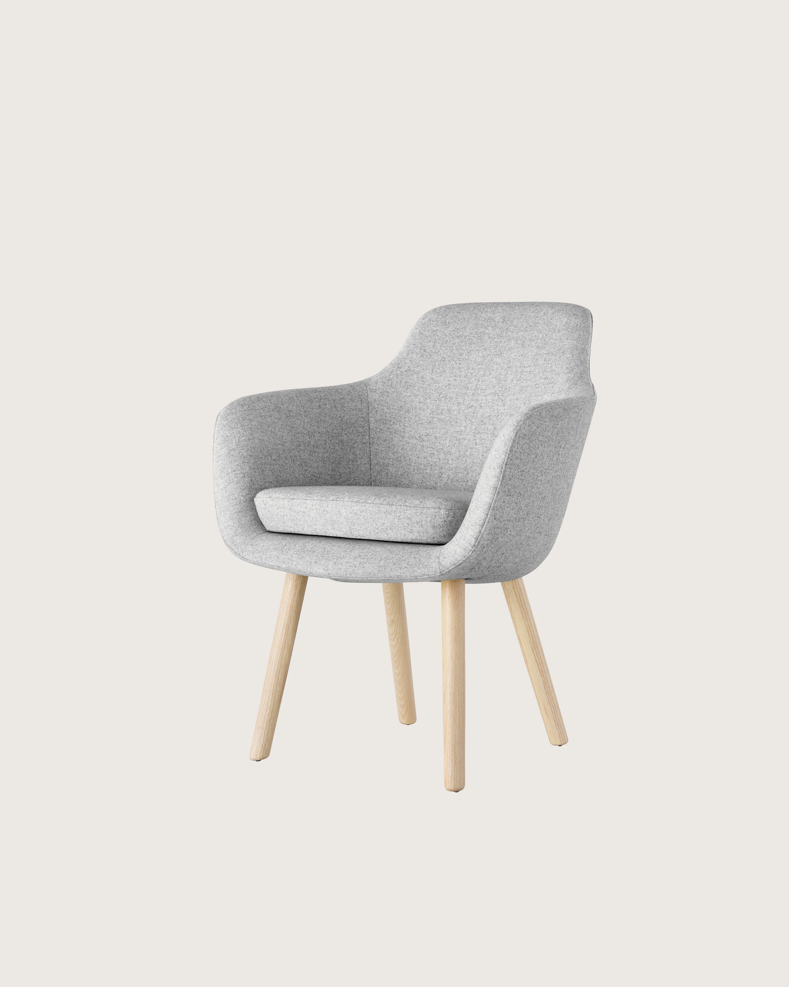Angled view of a Saiba Side Chair with light gray upholstery and wood legs in a light finish.