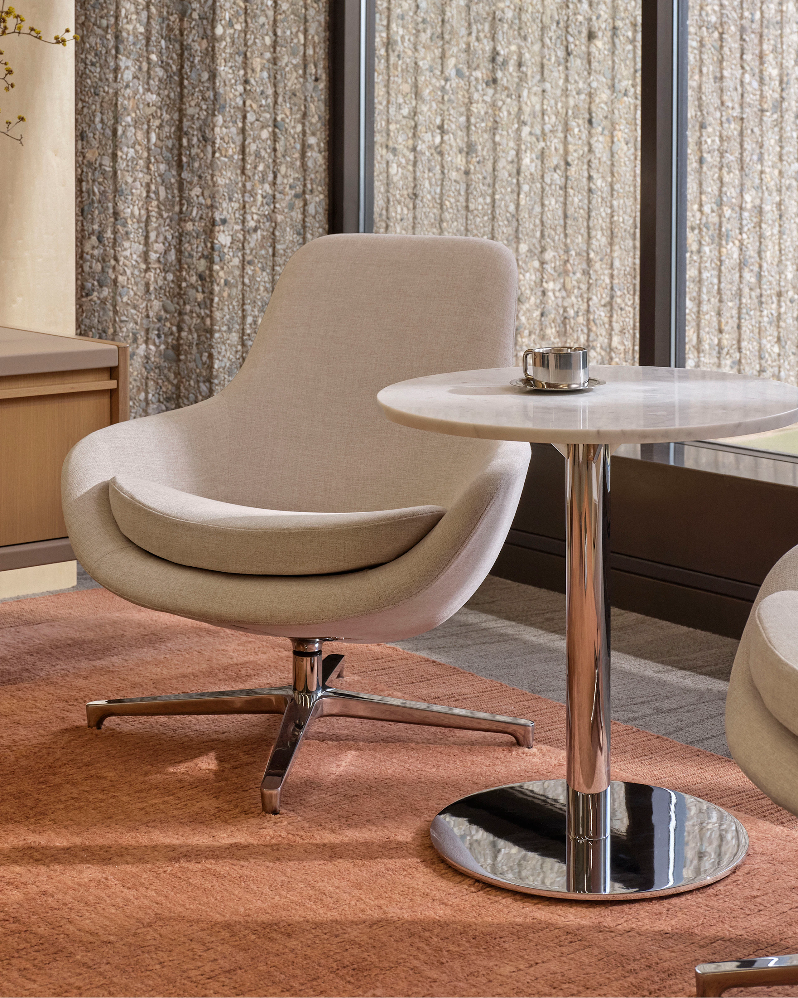 Saiba Lounge Chair upholstered in Vionette in Desert Mix with a polished aluminum base, shown with an NL Side Table and a New Canaan Media Unit in a lounge setting.