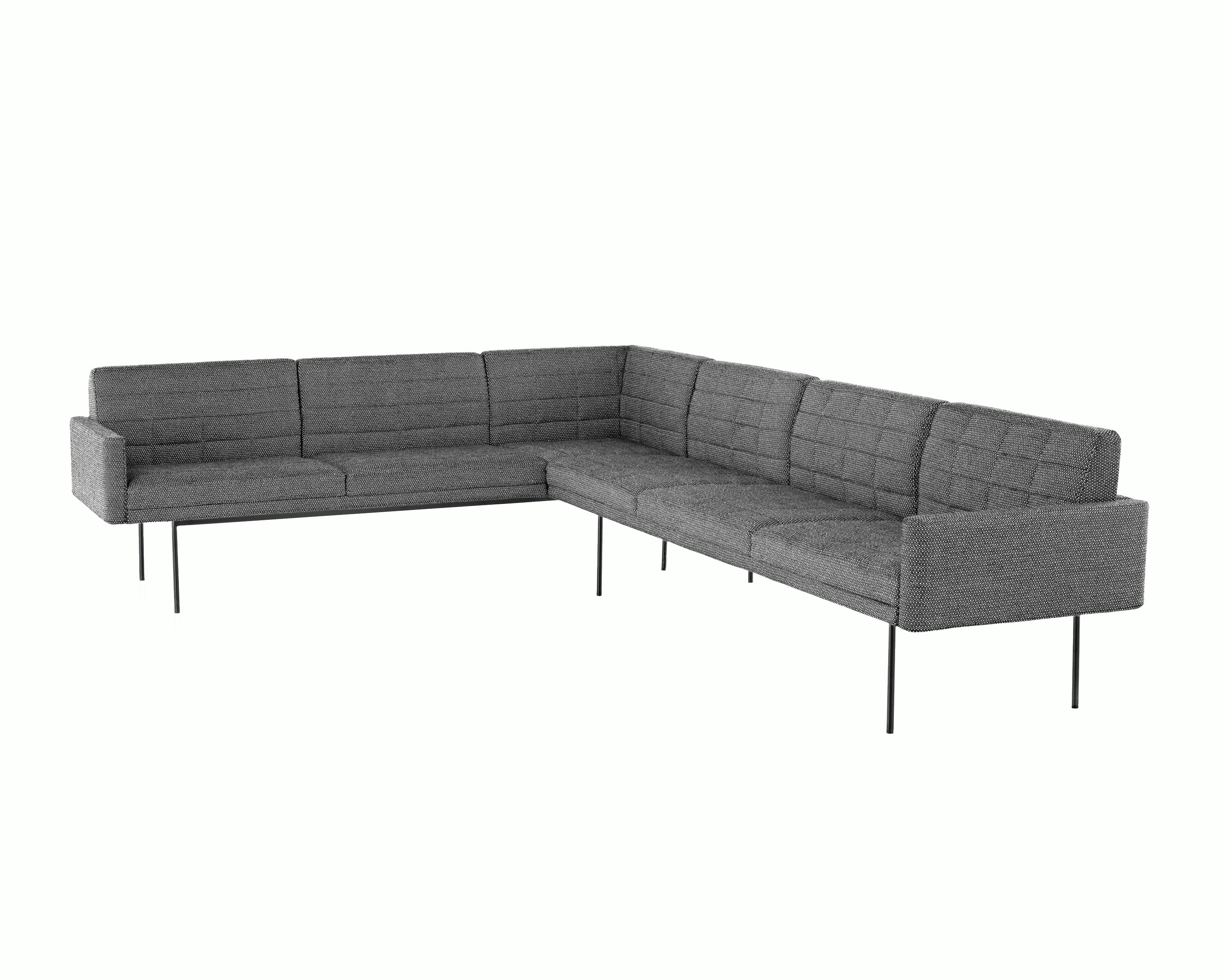A quilted Tuxedo Component sectional upholstered in gray fabric.