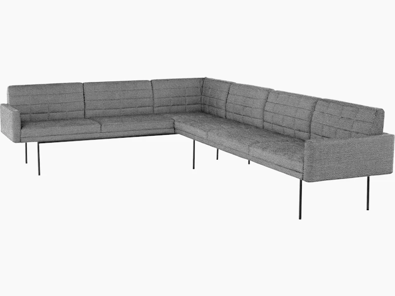 A quilted Tuxedo Component sectional upholstered in gray fabric.