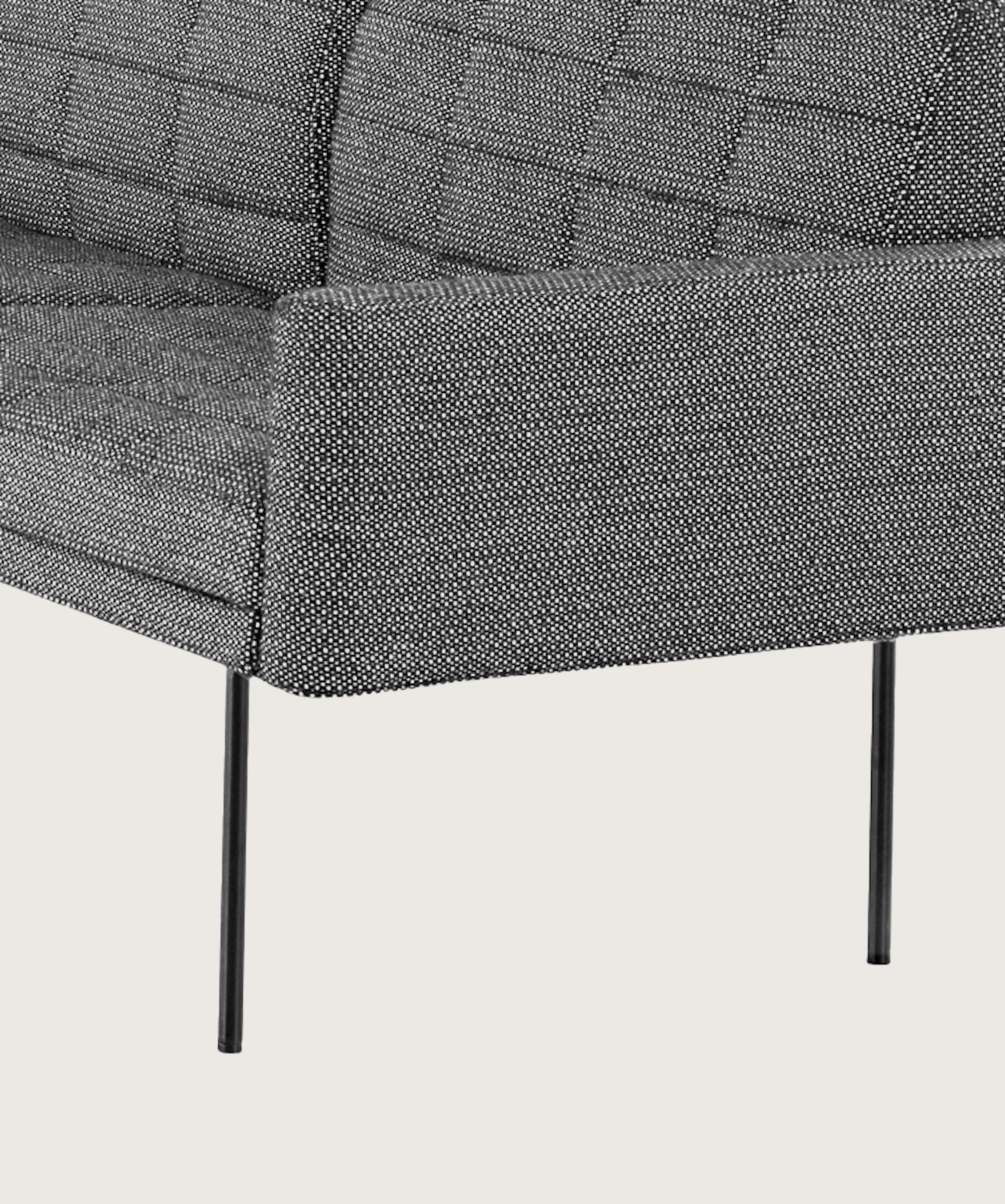 A quilted Tuxedo Component sectional upholstered in gray fabric.