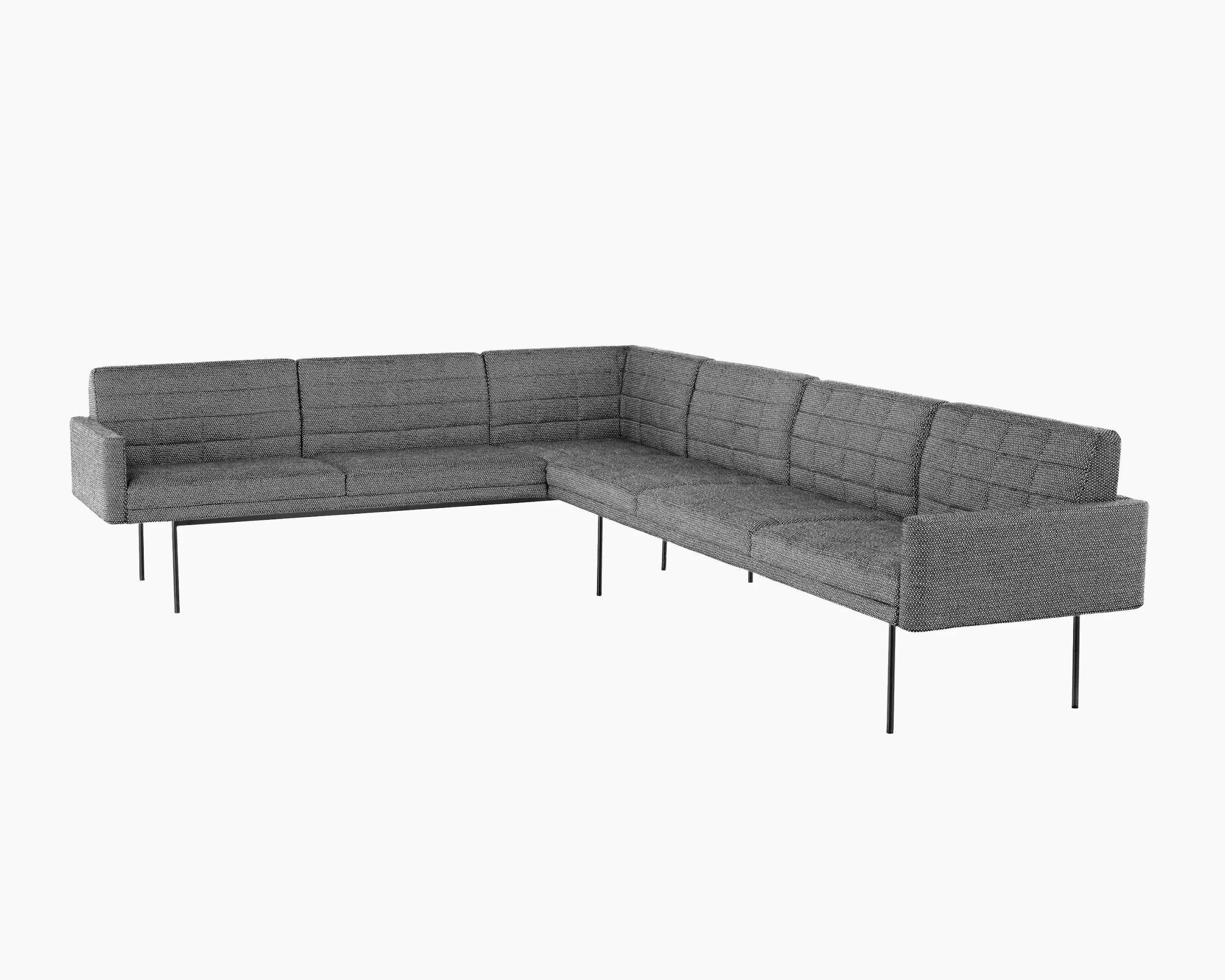 A quilted Tuxedo Component sectional upholstered in gray fabric.