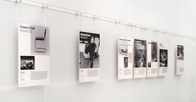 Informational placards for the Cesca Chair, Womb Chair, Eames Lounge Chair and Ottoman, and more on a wall display at the MillerKnoll Archives
