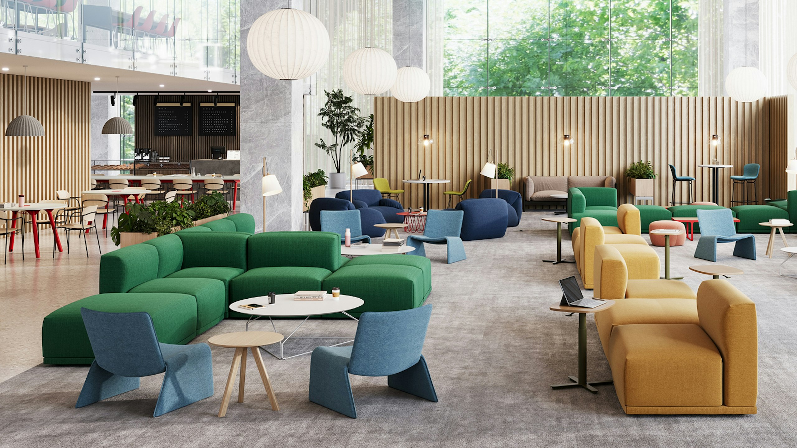 Seating area in a student lounge furnished with green Muuto Connect Modular sofas, blue NaughtOne Fin Lounge chairs, and Herman Miller Polygon Wire tables.