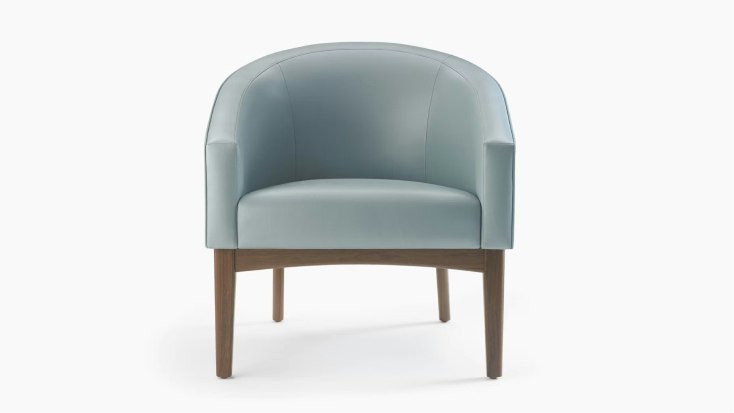 A Sophora Lounge Chair in light blue textile with a walnut base and legs.