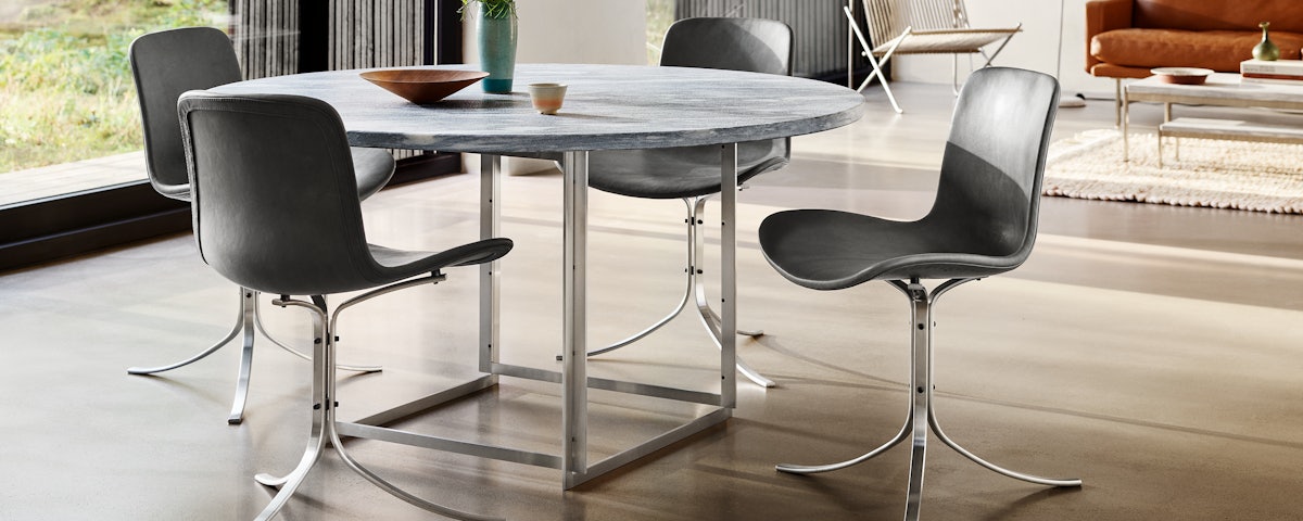 PK54 Dining Table surrounded by dining chairs in a dining room setting