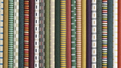 A close-up of a stack of colorful fabric with varying patterns.