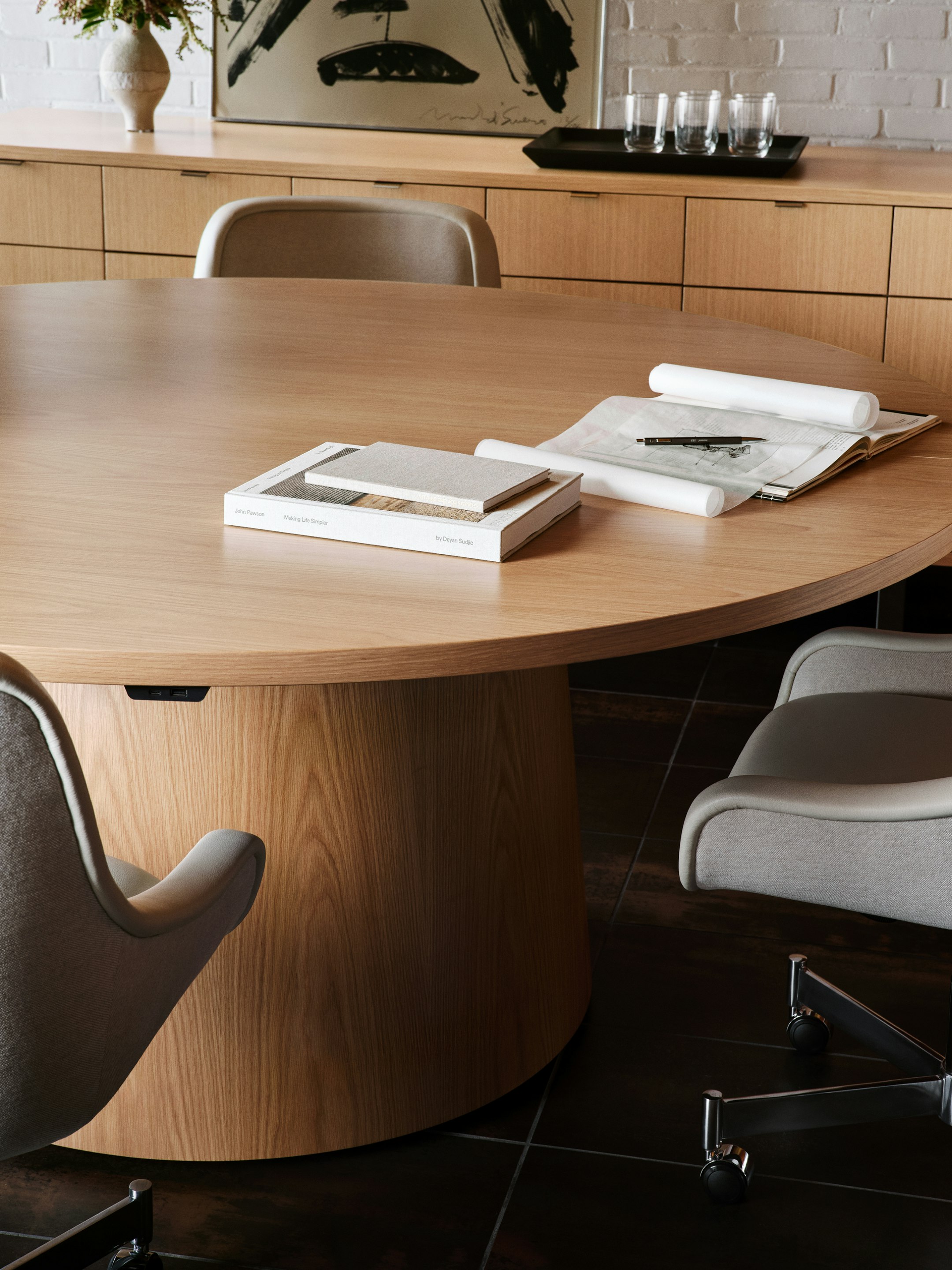 JD Meeting Table in natural flat cut oak shown surrounded by Bumper Chairs in front of a Highline 25 Credenza.