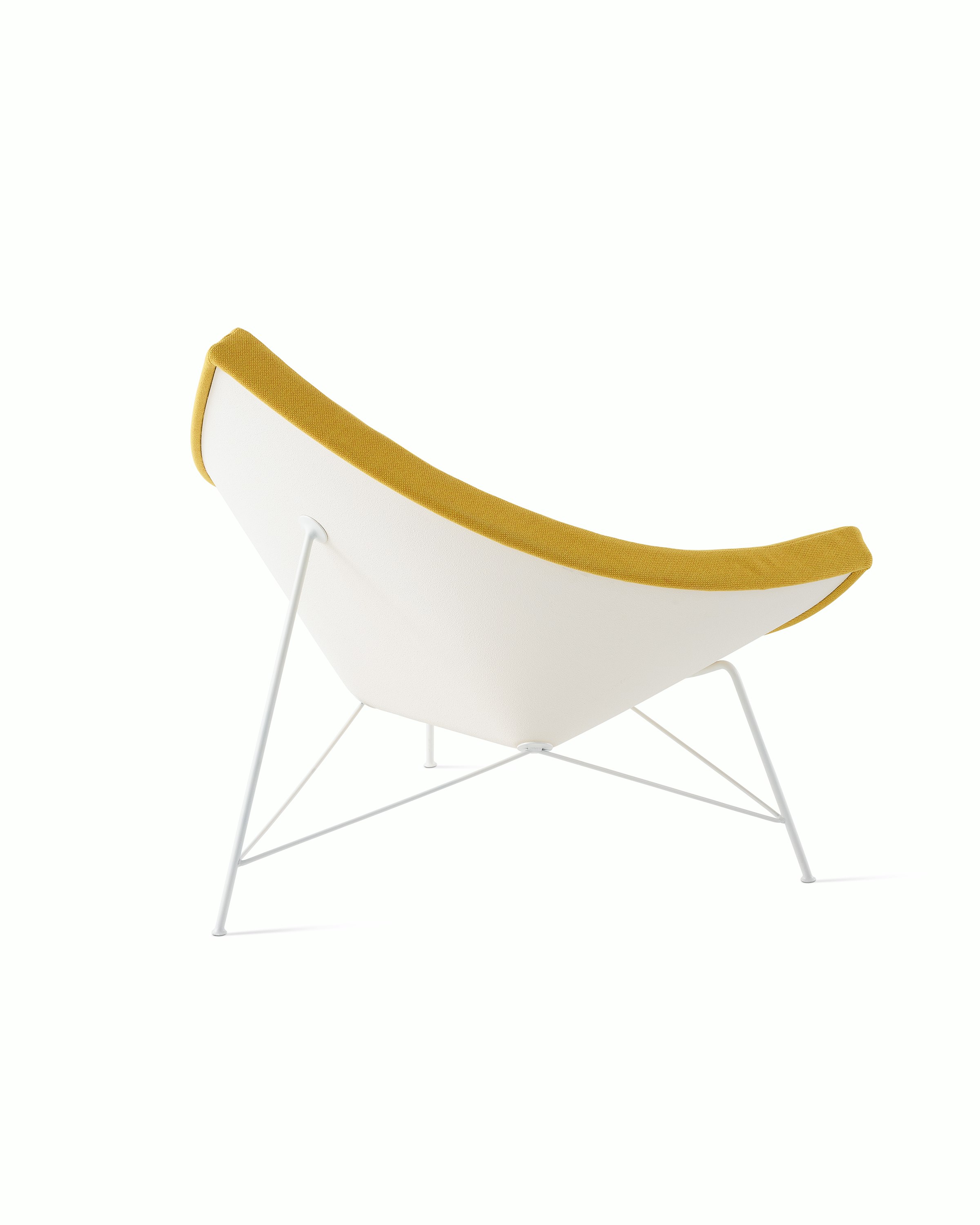 Three-quarter rear view of a  Nelson Coconut Lounge Chair with yellow Mode  fabric, focusing on the white shell.