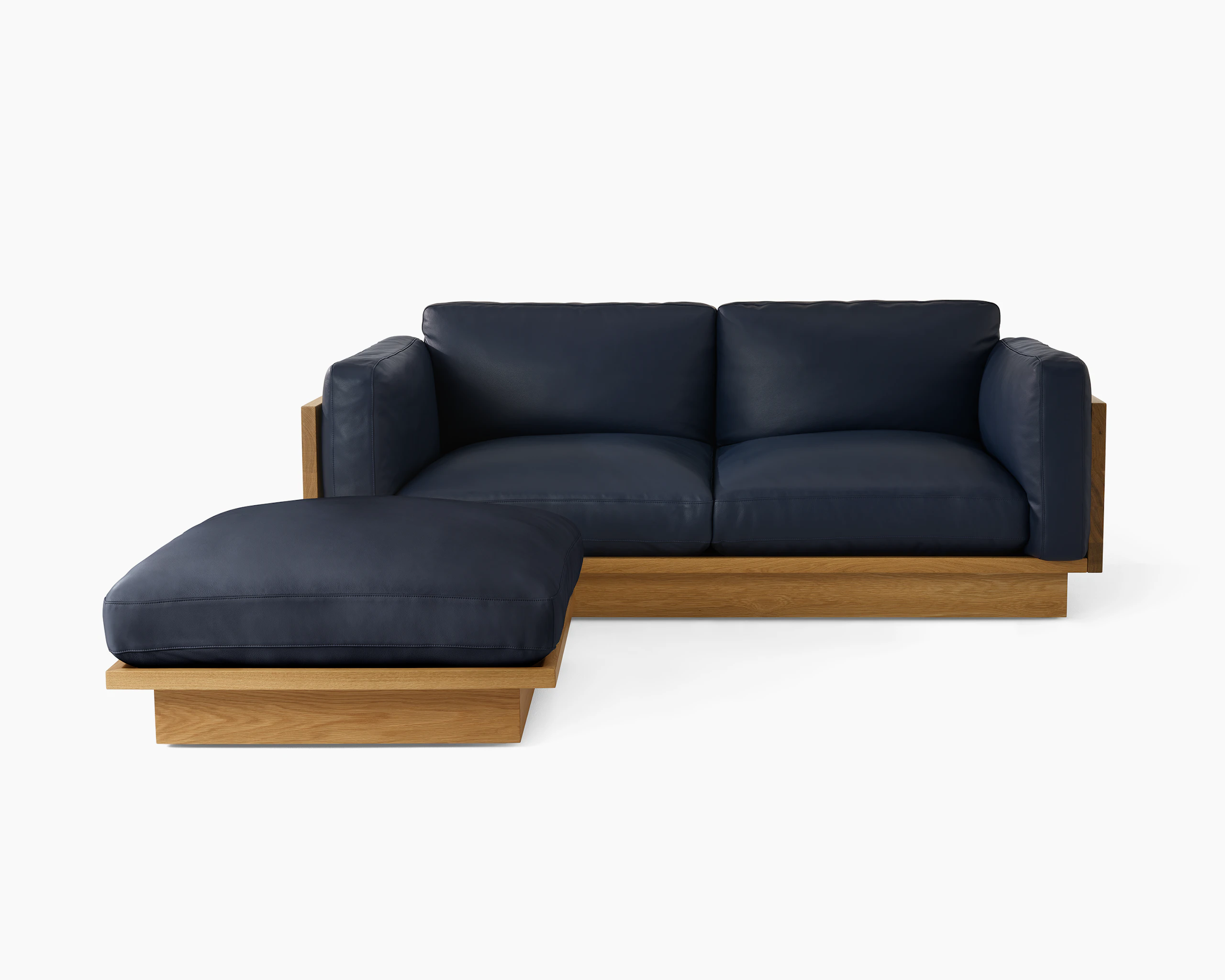 Pawson Drift Sofa and Ottoman with white oak frame and blue leather upholstery.