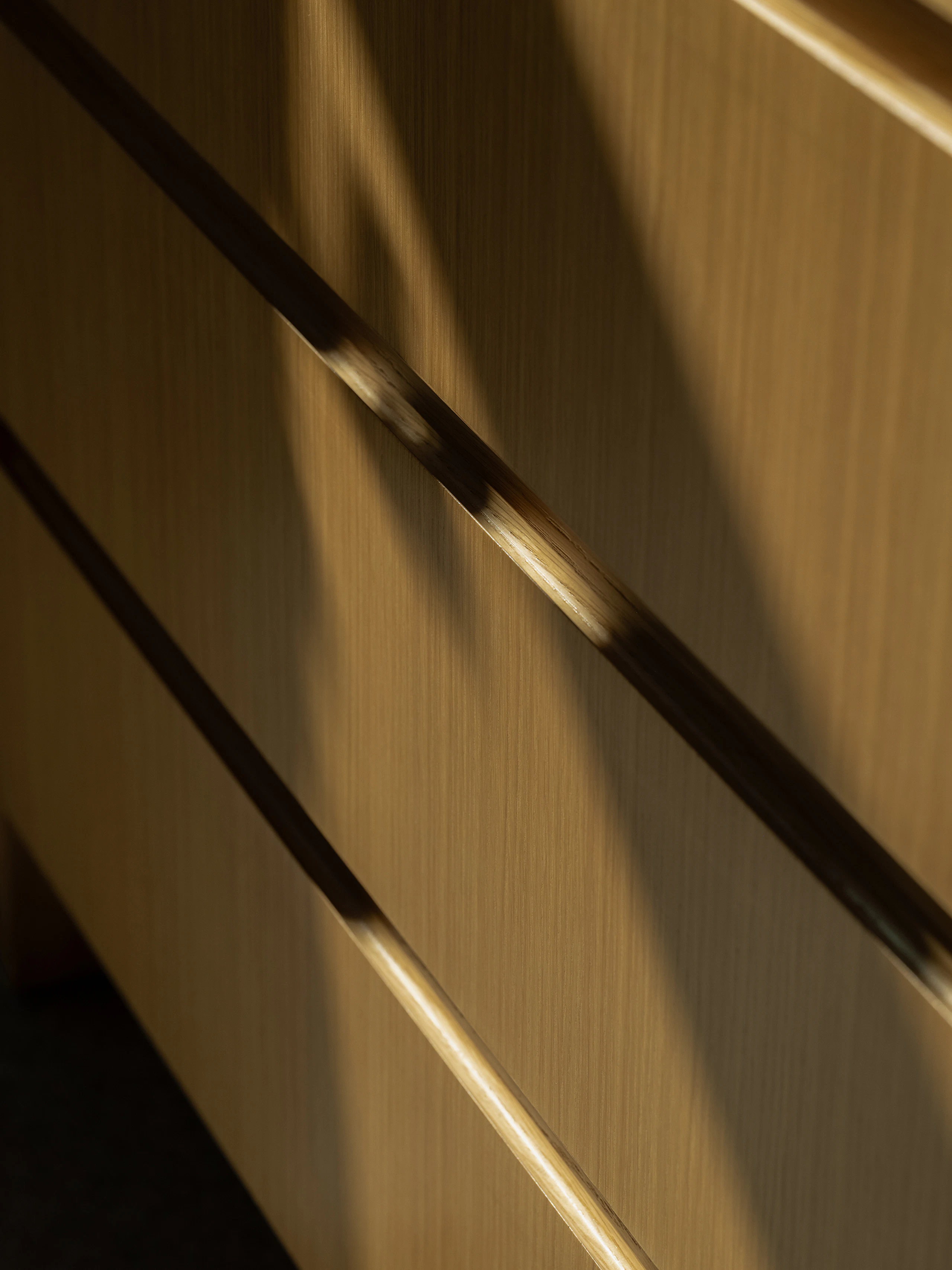 Geiger New York Showroom custom storage detail shot of the front of a natural rift cut oak credenza.