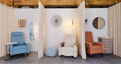 Several Nemschoff healthcare recliners, one blue, one white, and one orange, in three displays at the MillerKnoll healthcare showroom at Design Days