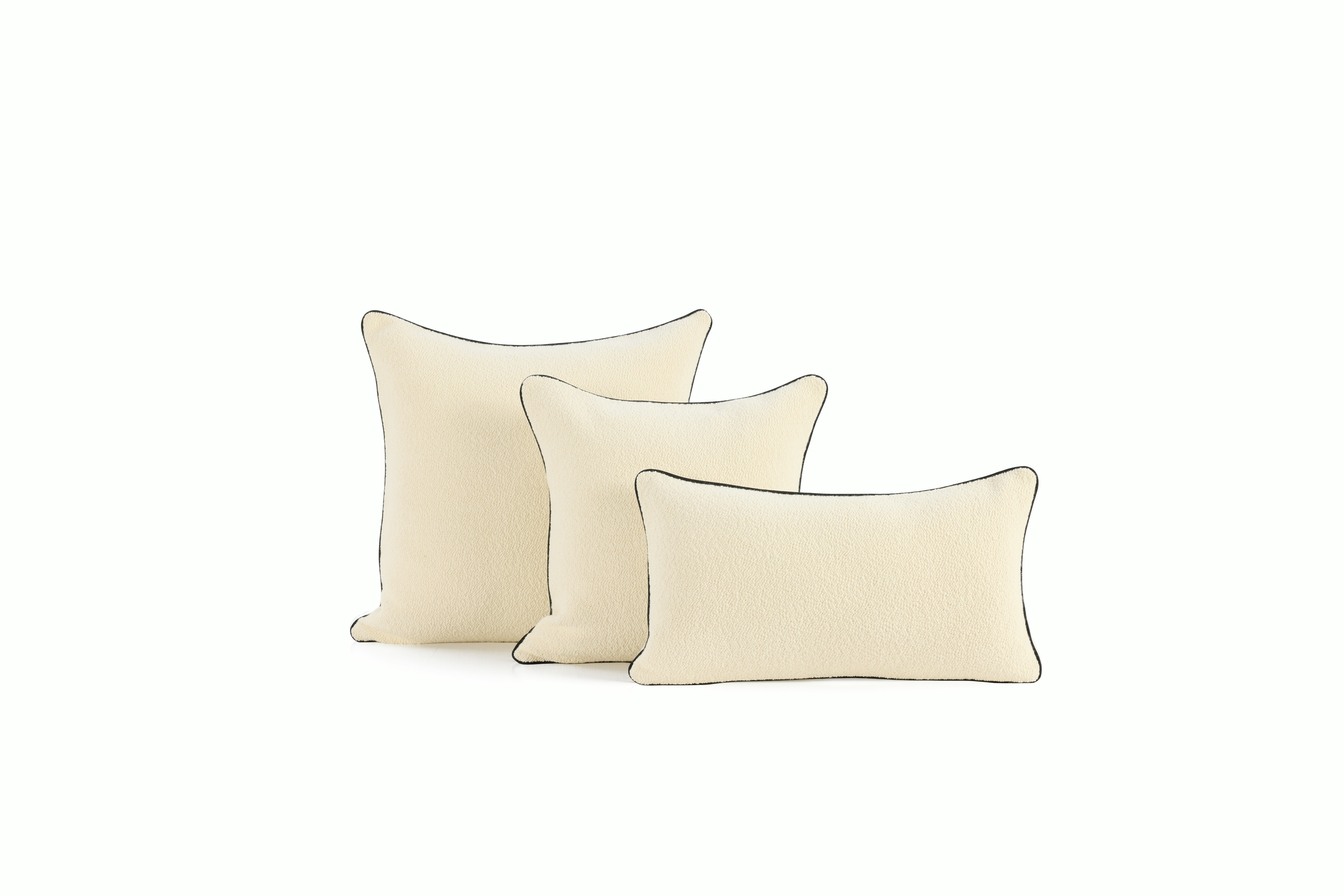 An environmental shot of a Turf Color Blocked Pillow in Cream Melange Cream V1.