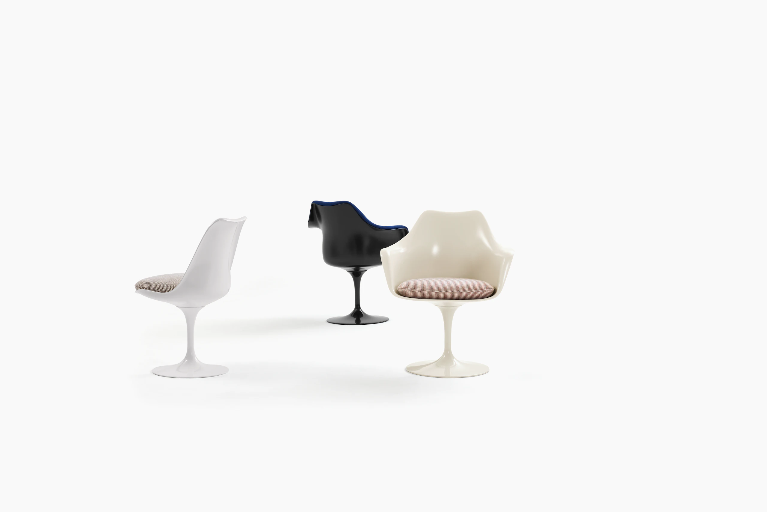 Three Tulip Chairs with white and black bases and pink and brown seats.