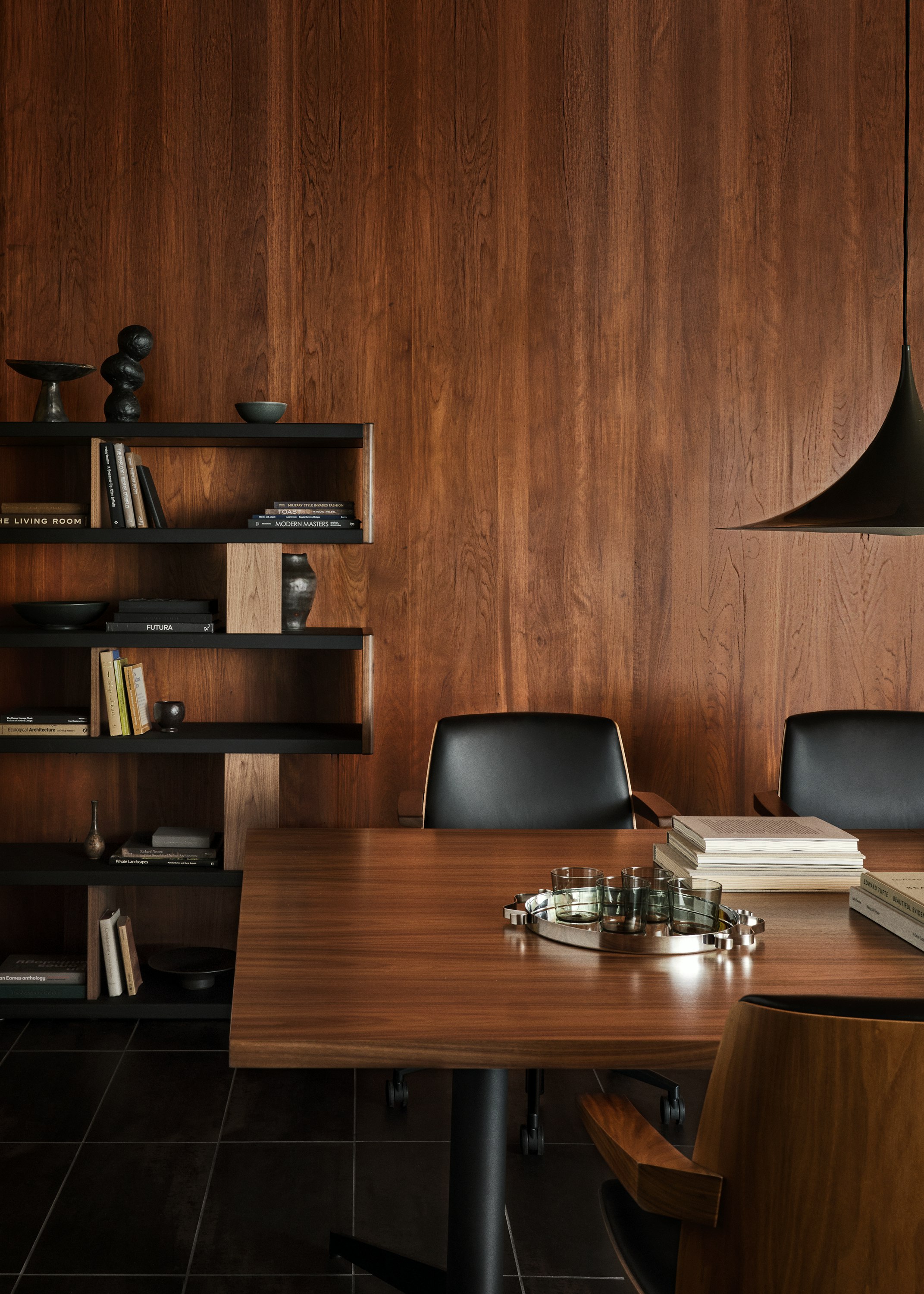 MP Table designed by Amir Paknya for Geiger in Natural Flat Cut Walnut shown with Low-Back Clamshell Chairs and a New Canaan Bookshelf.