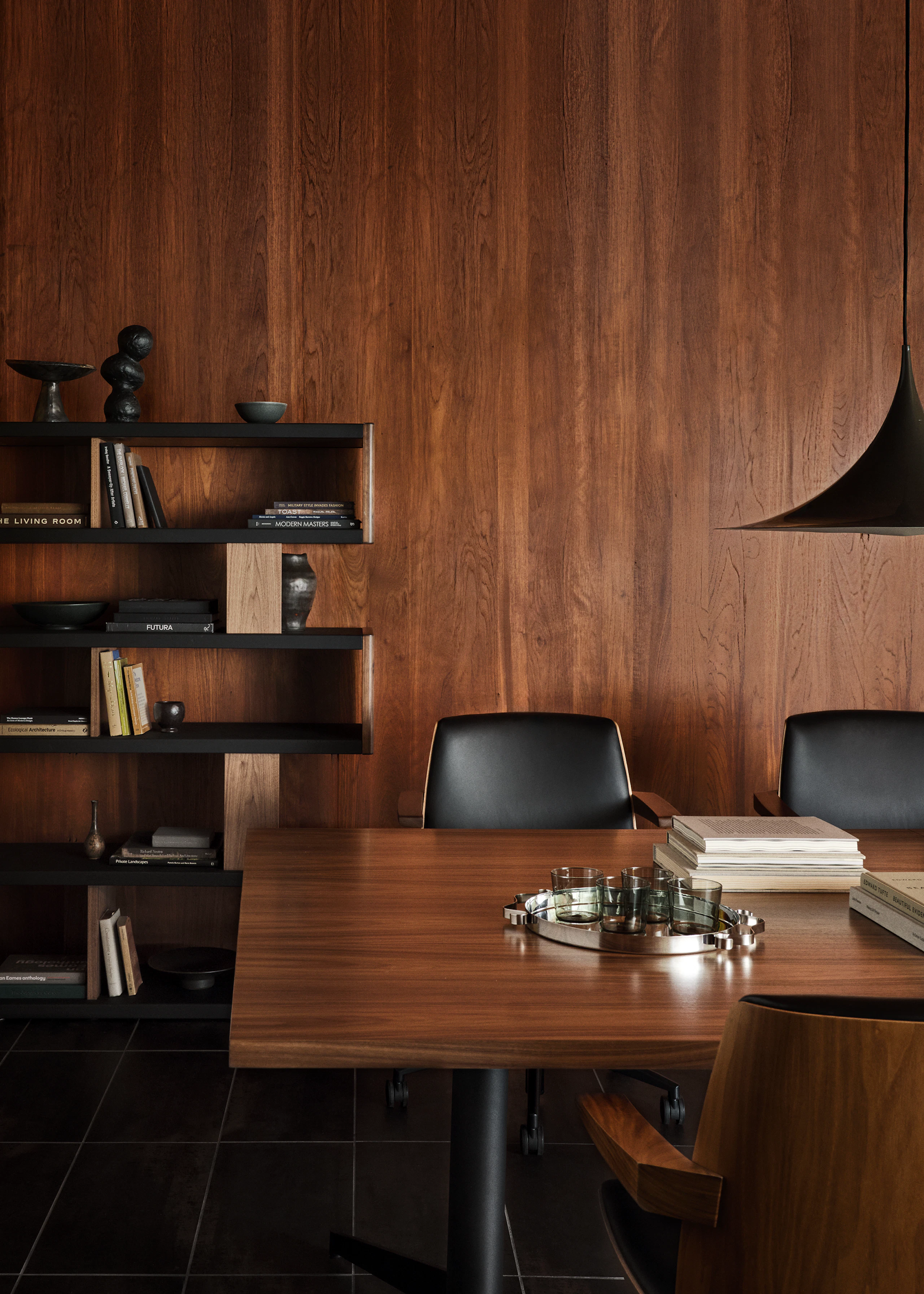 MP Table designed by Amir Paknya for Geiger in Natural Flat Cut Walnut shown with Low-Back Clamshell Chairs and a New Canaan Bookshelf.