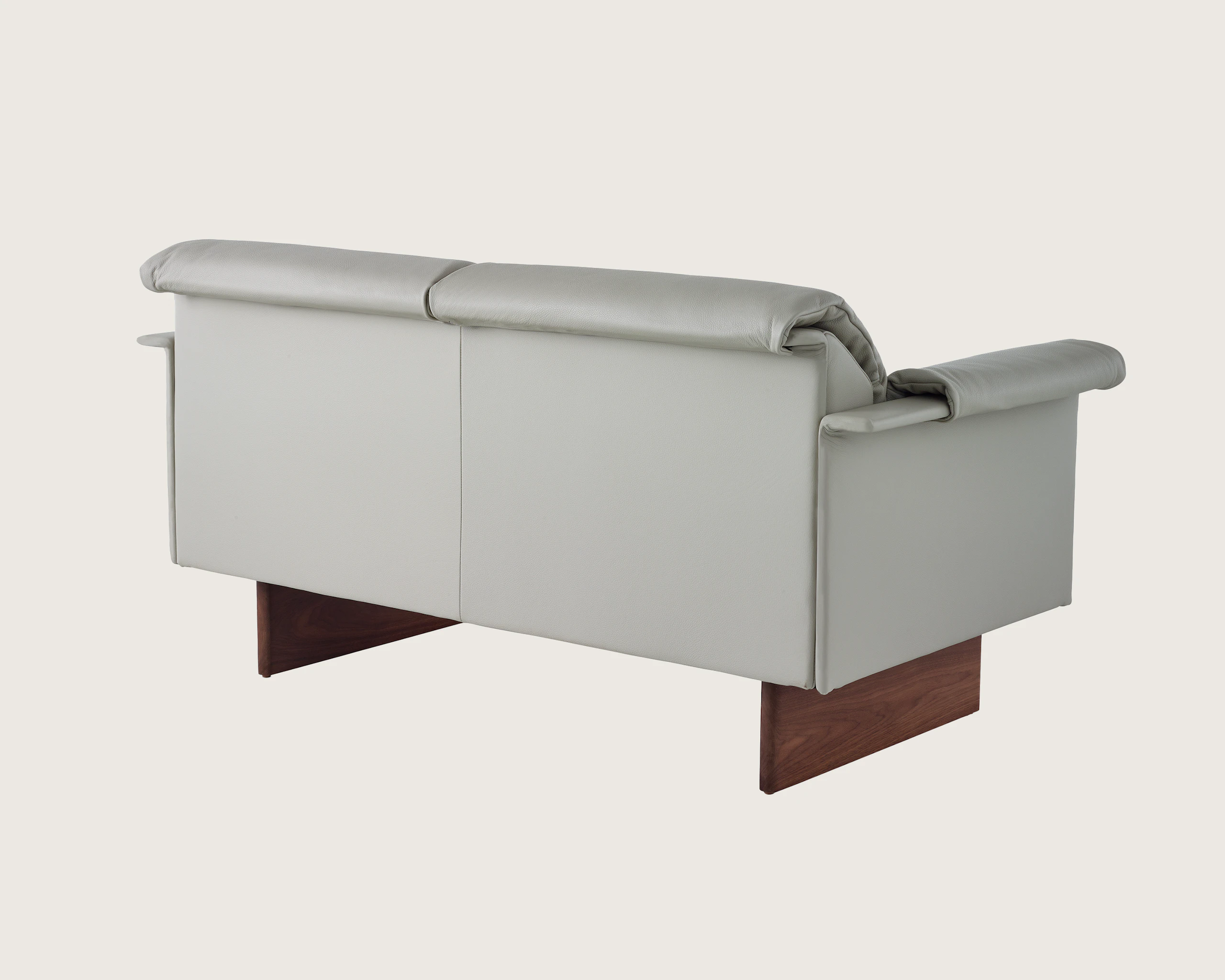 Mantle Two Seater Sofa in Bristol Leather Ash Grey with Wood Base, viewed at angle.