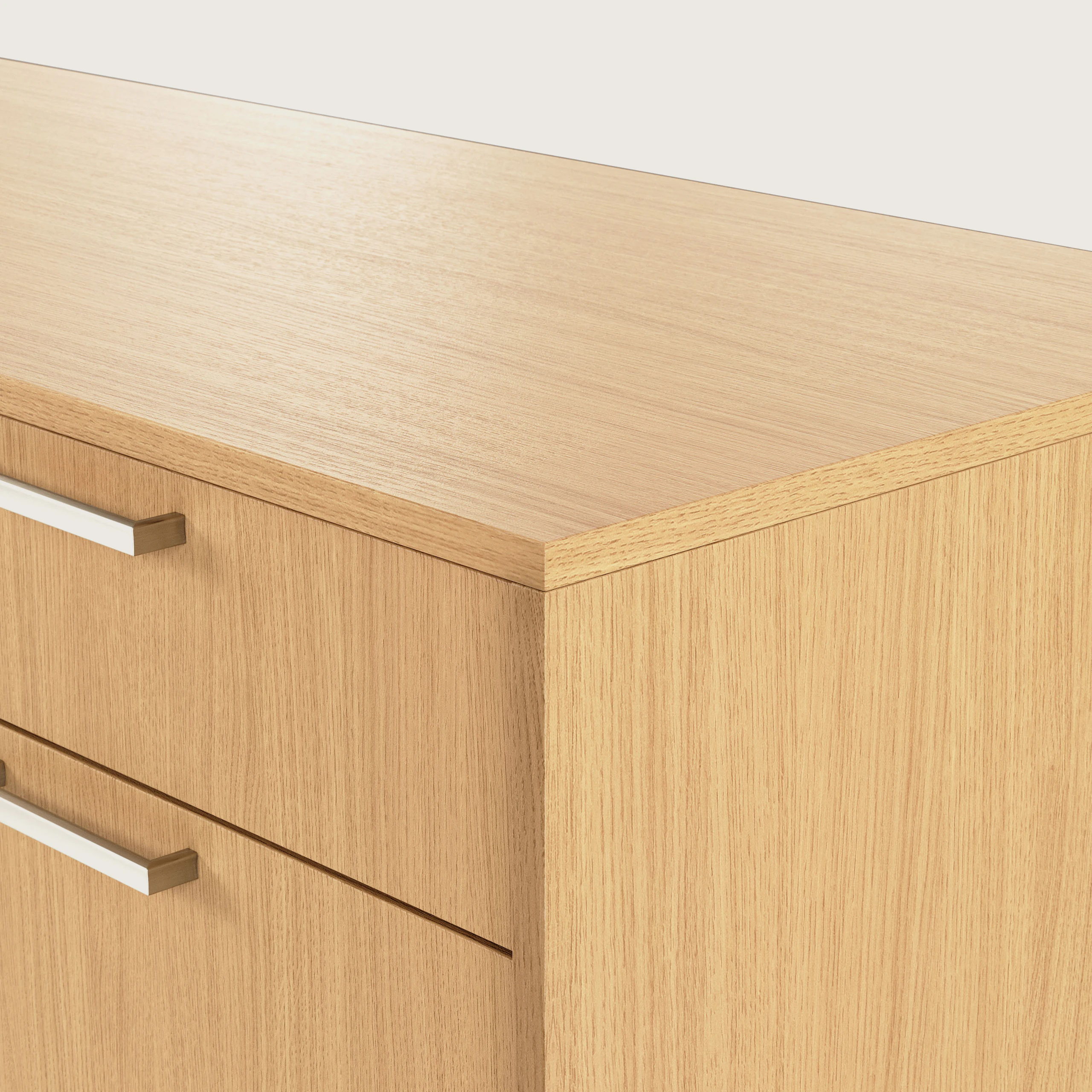 Detail shot of the edge of a JD Credenza with one box drawer over a fridge drawer in Natural Rift Cut Oak with Satin Nickel drawer pulls.