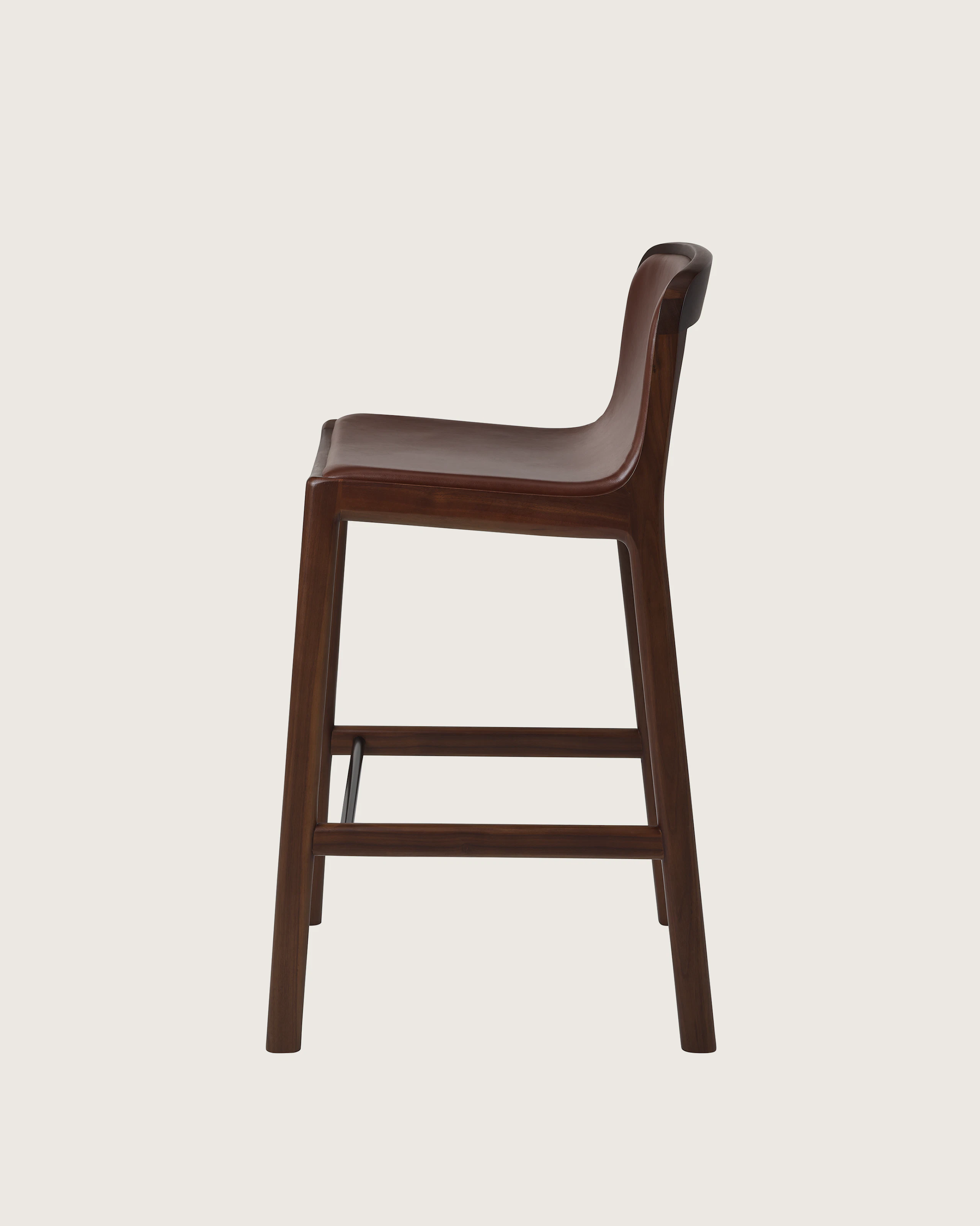 Lijn Stool by Carole Baijings for Geiger in Persian Walnut frame upholstered with Maharam Hue Leather in Bittersweet, side view on a white sweep.