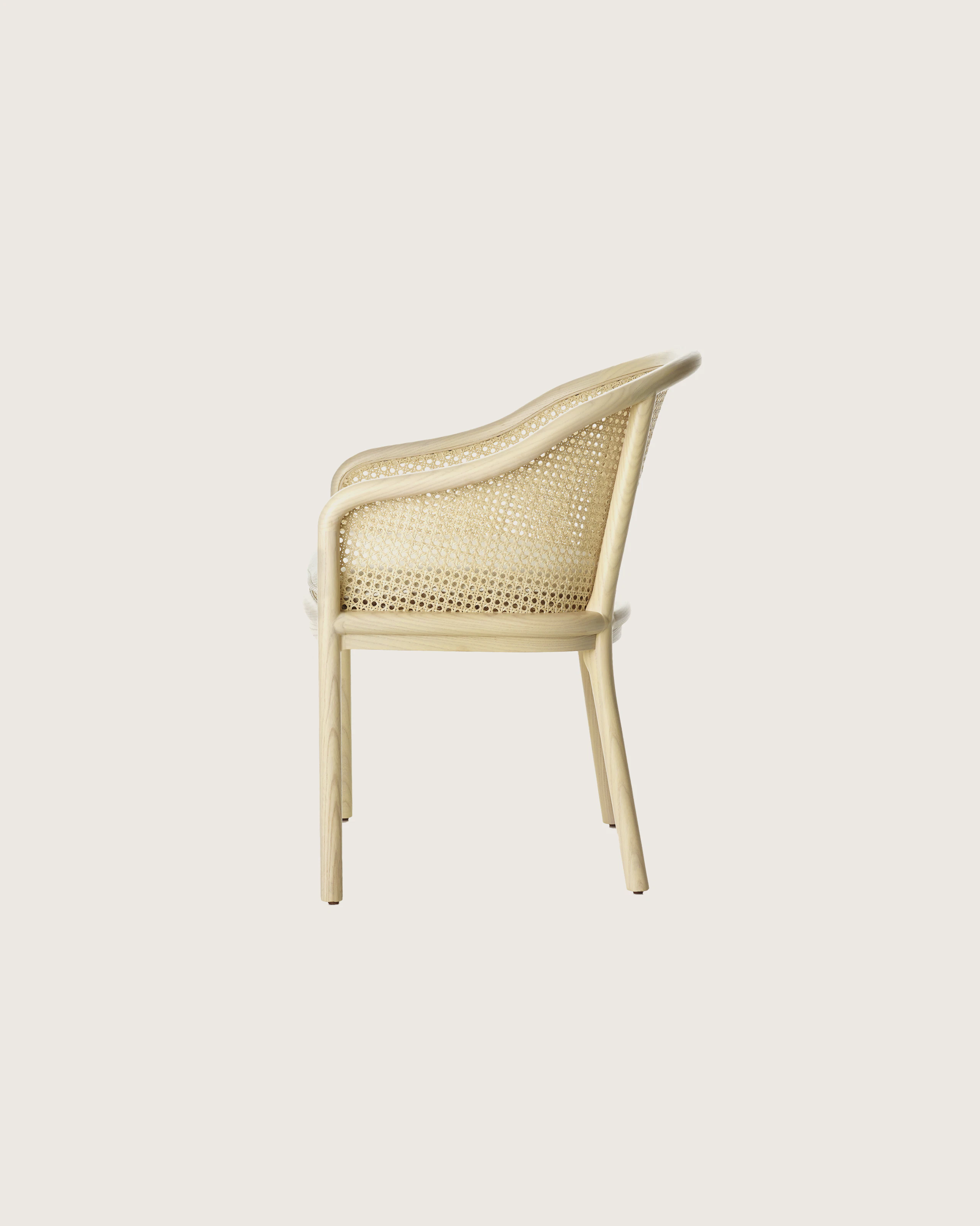 Landmark Chair with a cane back and a seat upholstered in a Double Beam textile, viewed from the side.