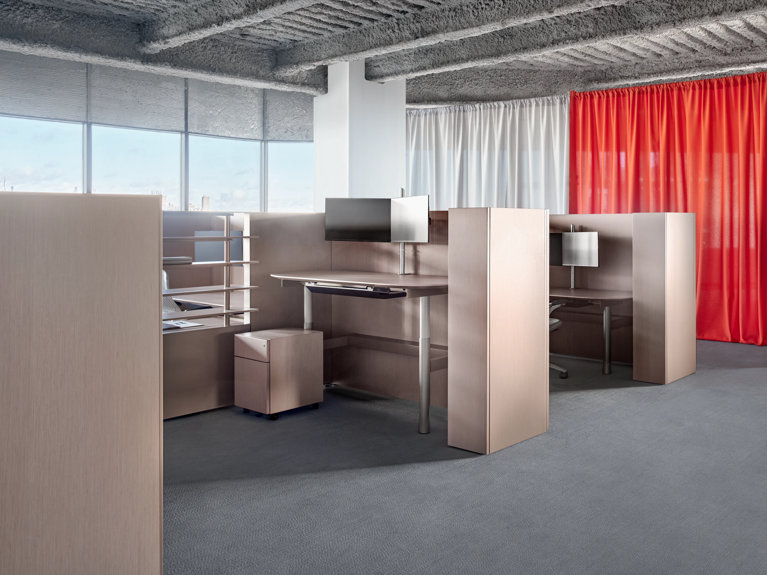 A group of workstations viewed from an angle. The workstations have high panels, open shelves, personal storage as well as a small locker.