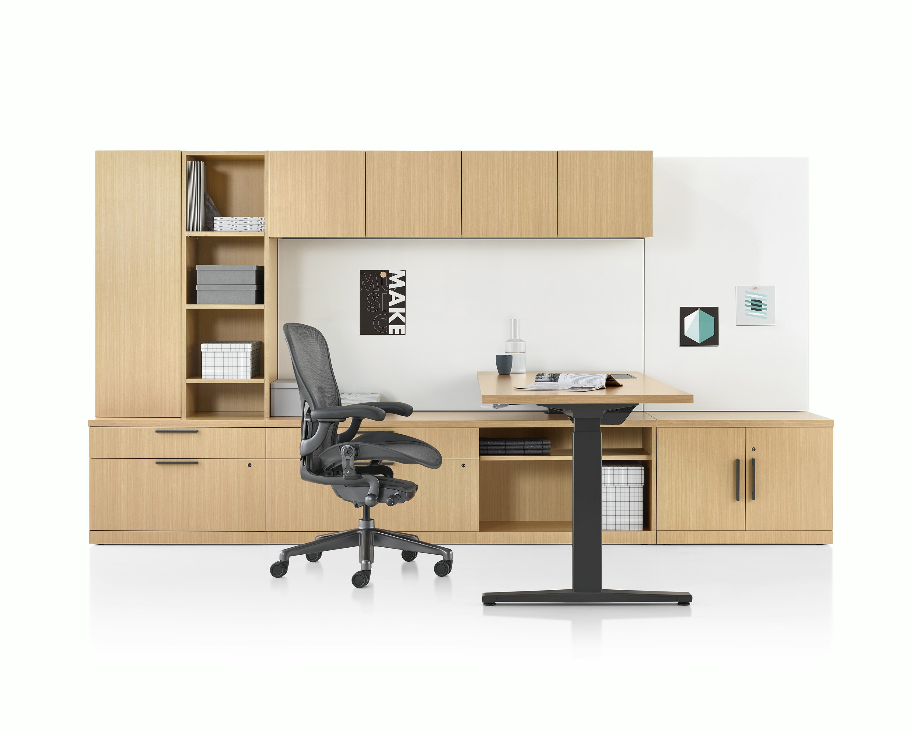 A Canvas Private Office with light wood storage, height adjustable desk, and black Aeron chair