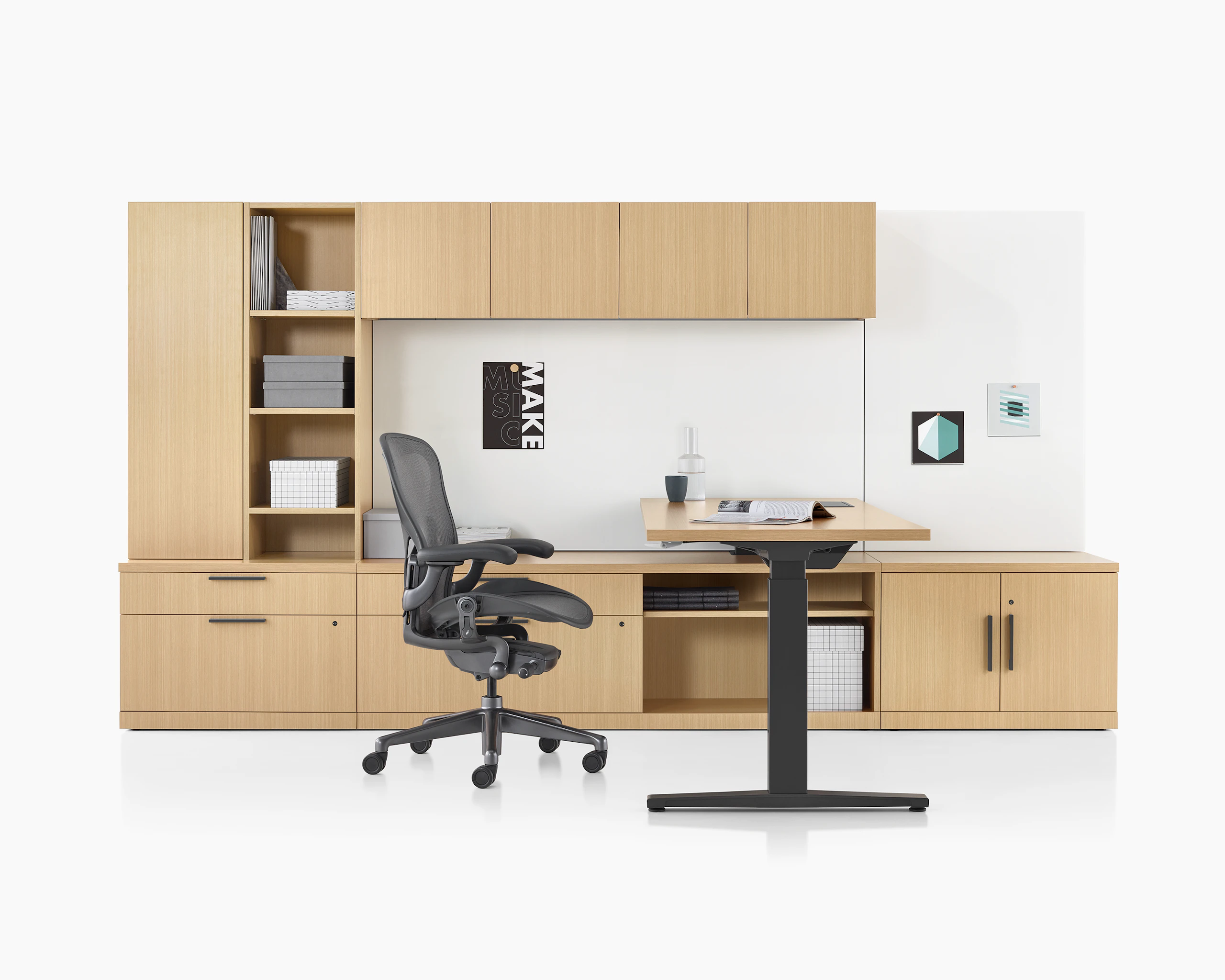 A Canvas Private Office with light wood storage, height adjustable desk, and black Aeron chair