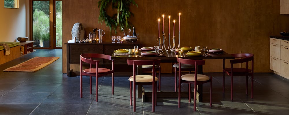 Land Table in oak with red comma chairs surrounding, and Heath earthenware on top