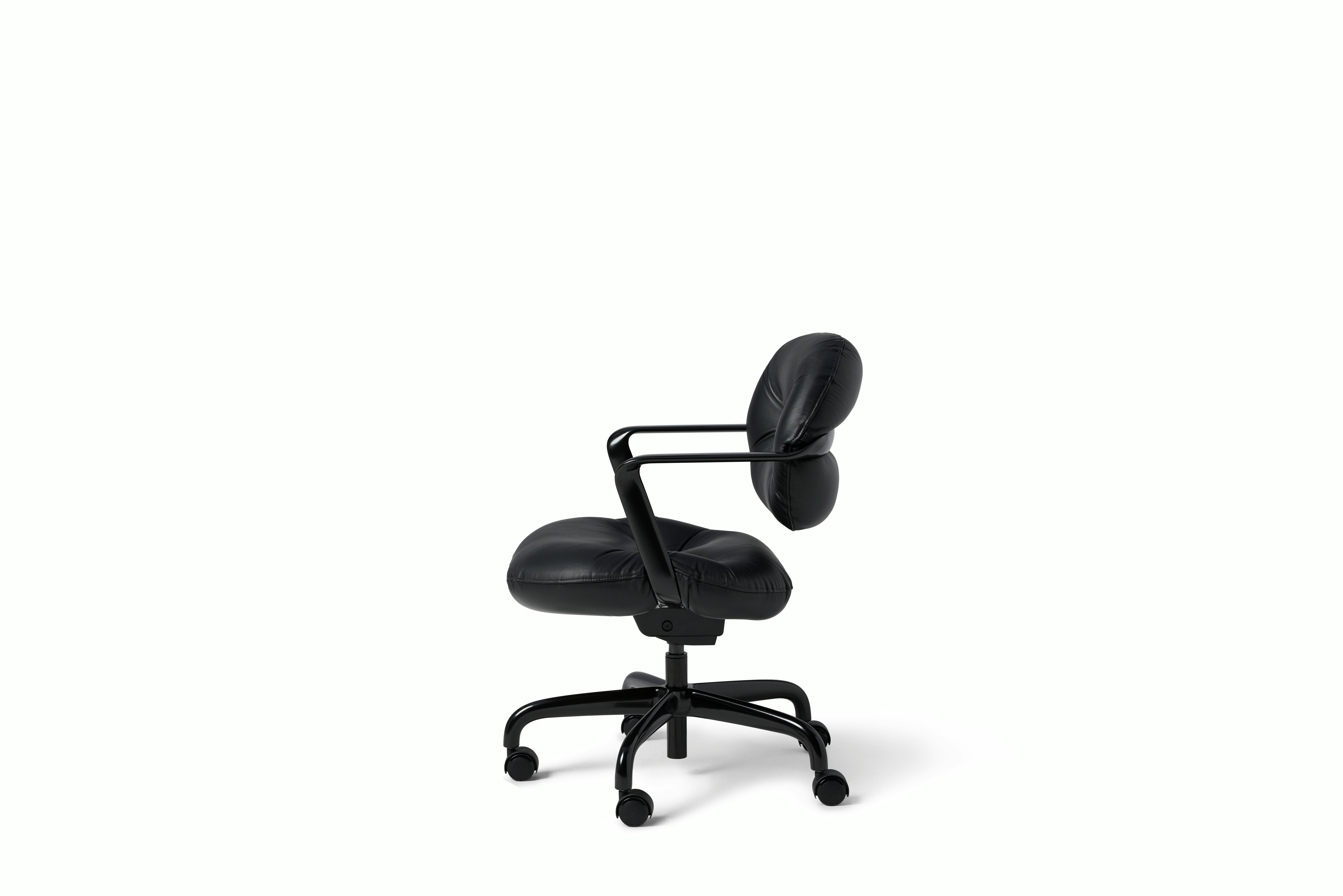 Side view of a Morrison Hannah chair with a black frame and base with fixed arms and black leather upholstery.