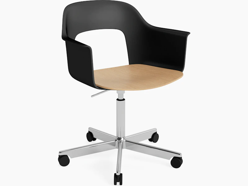 Layout Armchair black polypropylene arm shell with oak veneer seat on polished aluminum 5-star base with casters, front angled view.