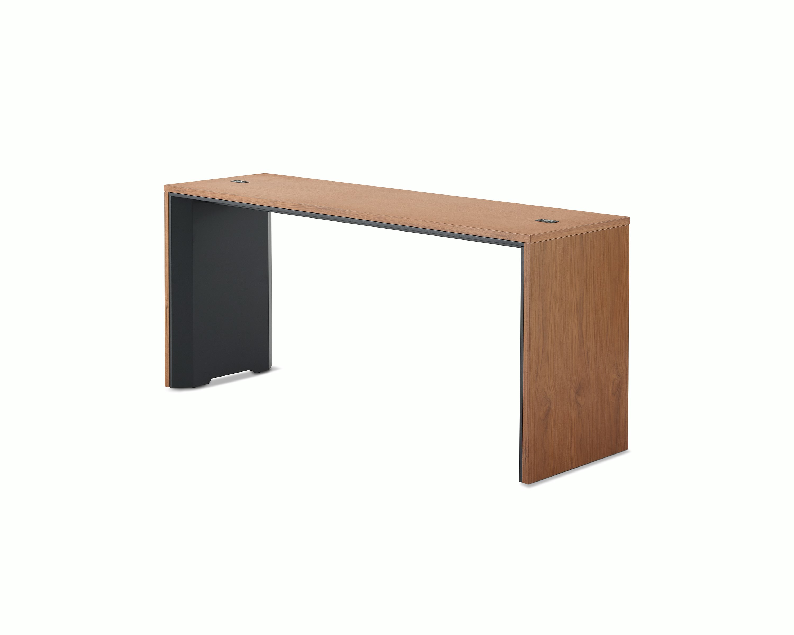A narrow communal Headway table at counter height with a medium wood top and black base viewed at a 45-degree angle.