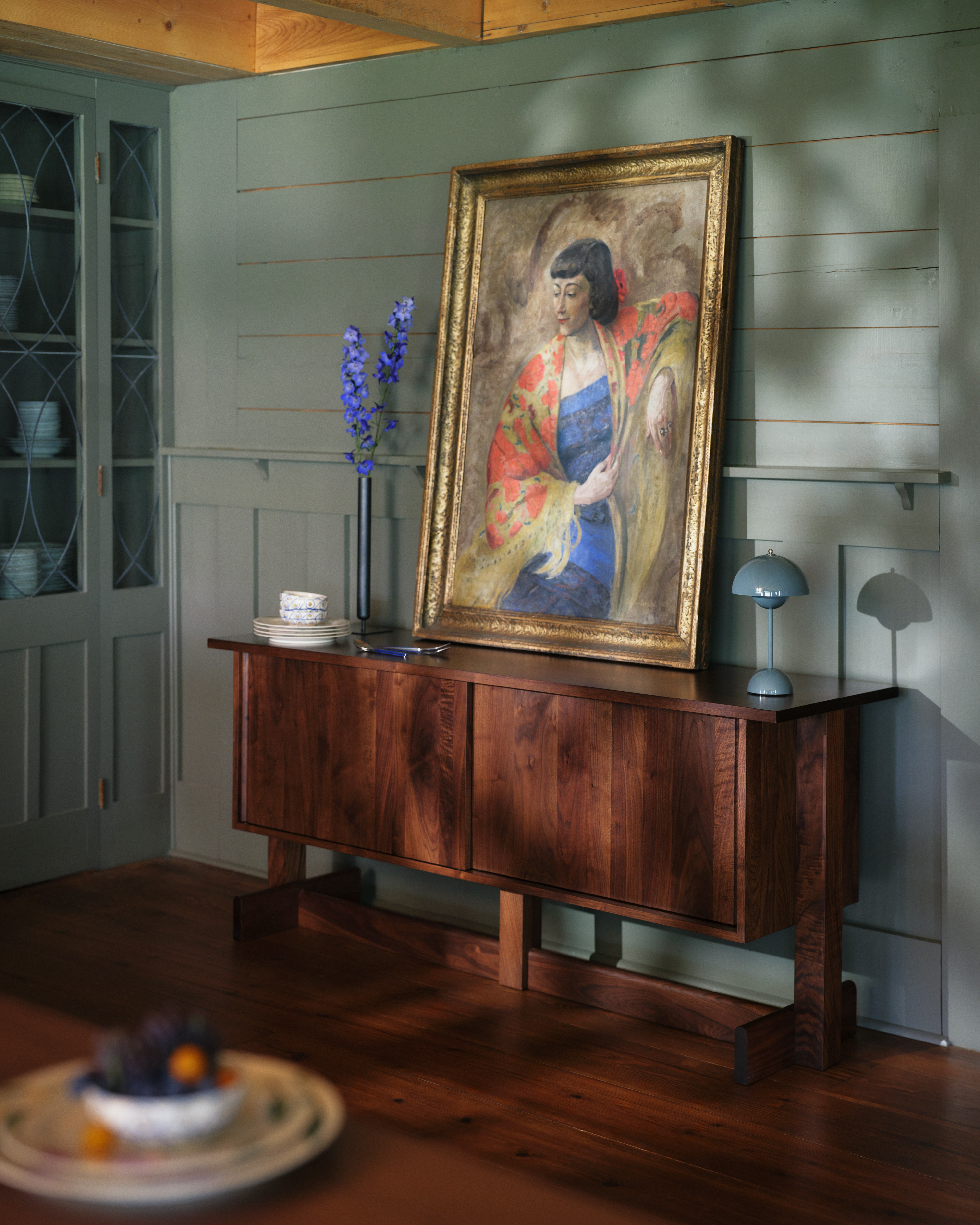 Dark brown Land Storage credenza, viewed in a living room with art