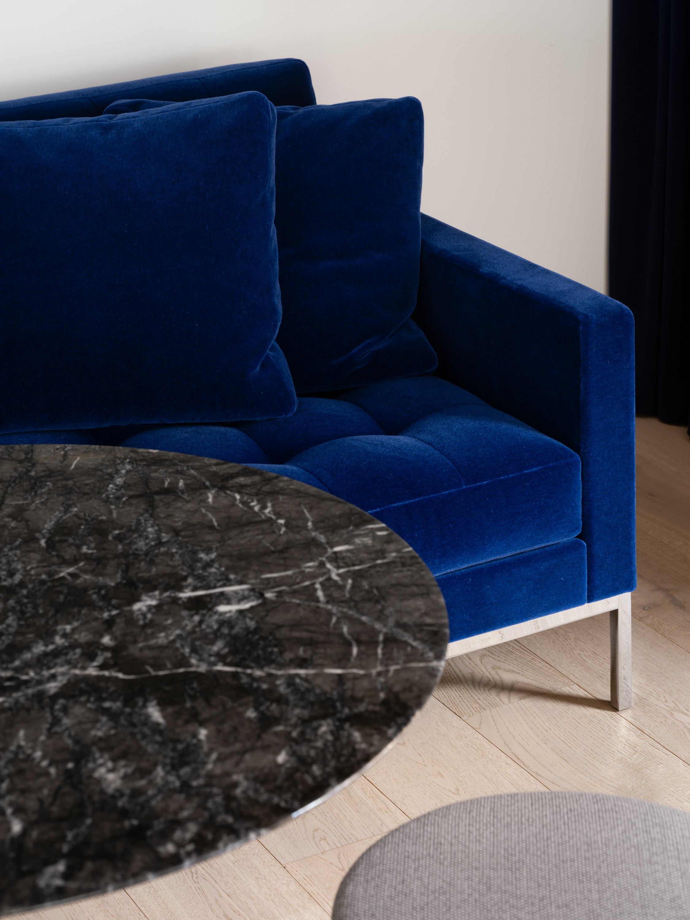 Detail shot of a Florence Knoll Sofa, Saarinen Dining Table and Saarinen Tulip Stool.