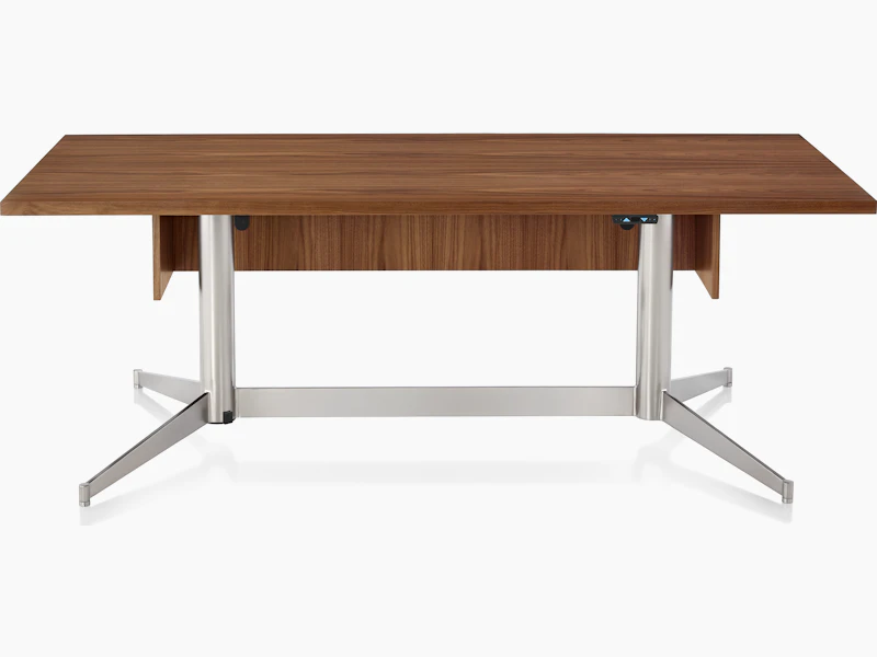 A rectangular MP Height-Adjustable Table in the seated position, viewed from the front and showing the height-adjustment button beneath the tabletop.