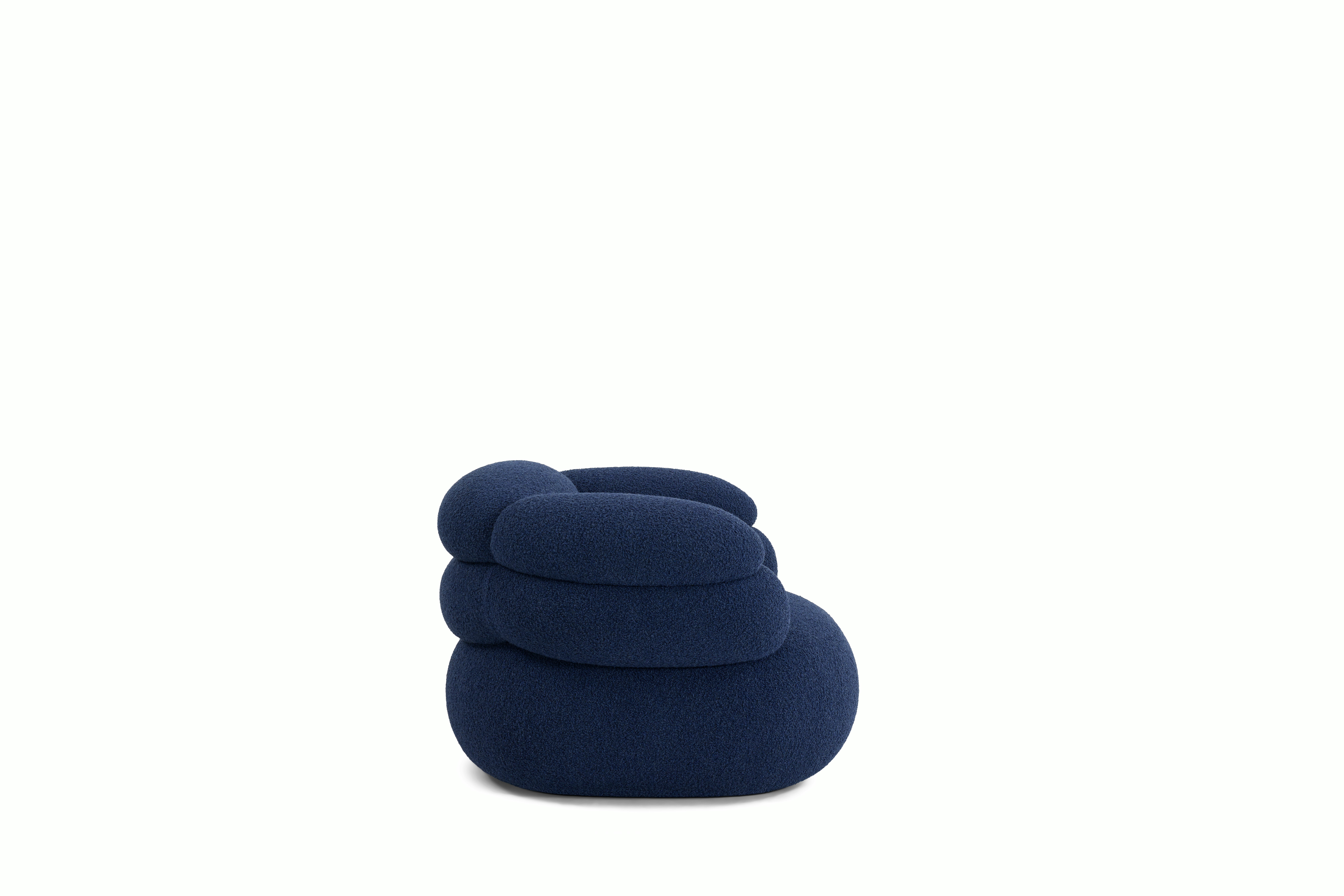 A Biboni Lounge Chair in Solid Sublime, Navy viewed from the side.