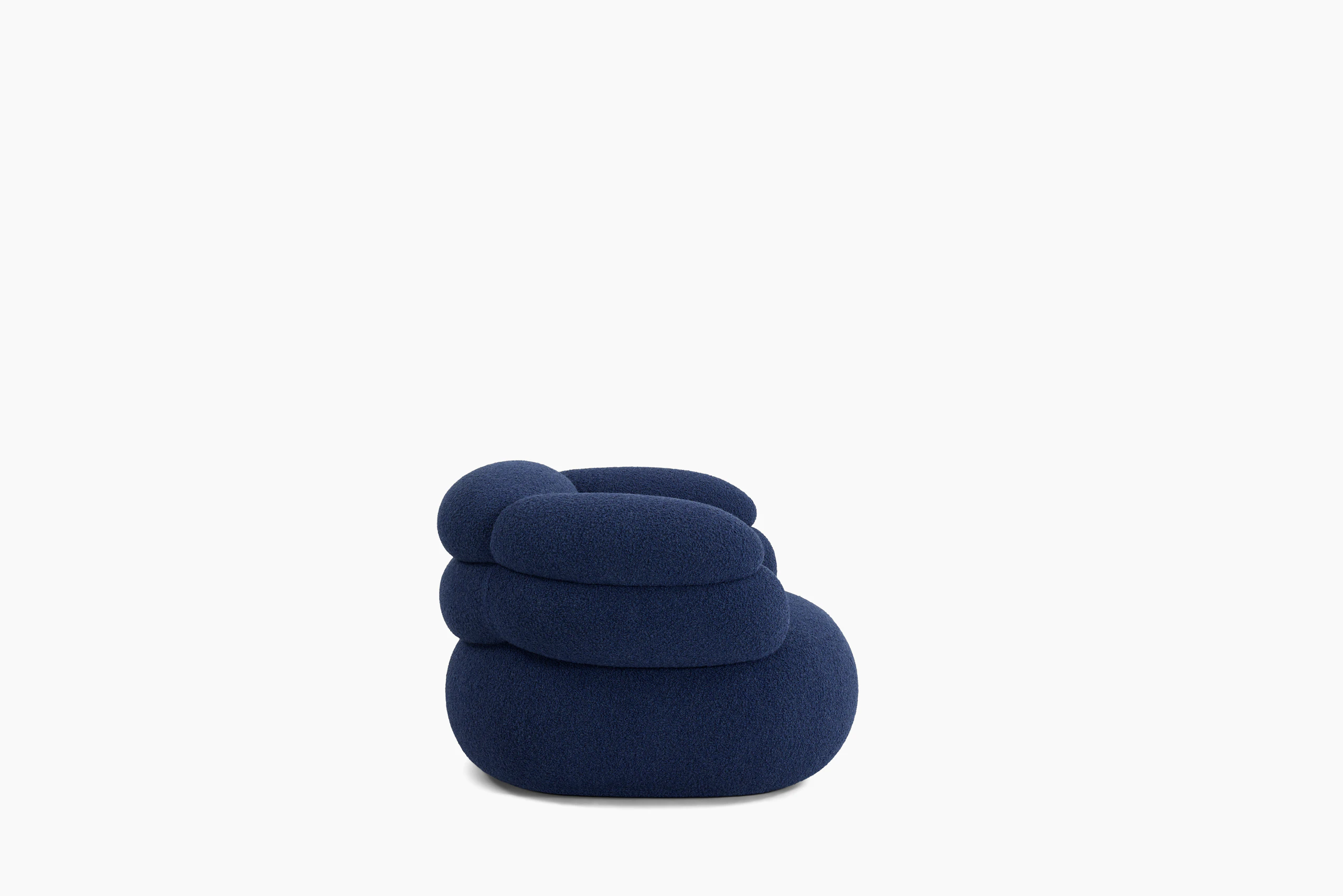 A Biboni Lounge Chair in Solid Sublime, Navy viewed from the side.